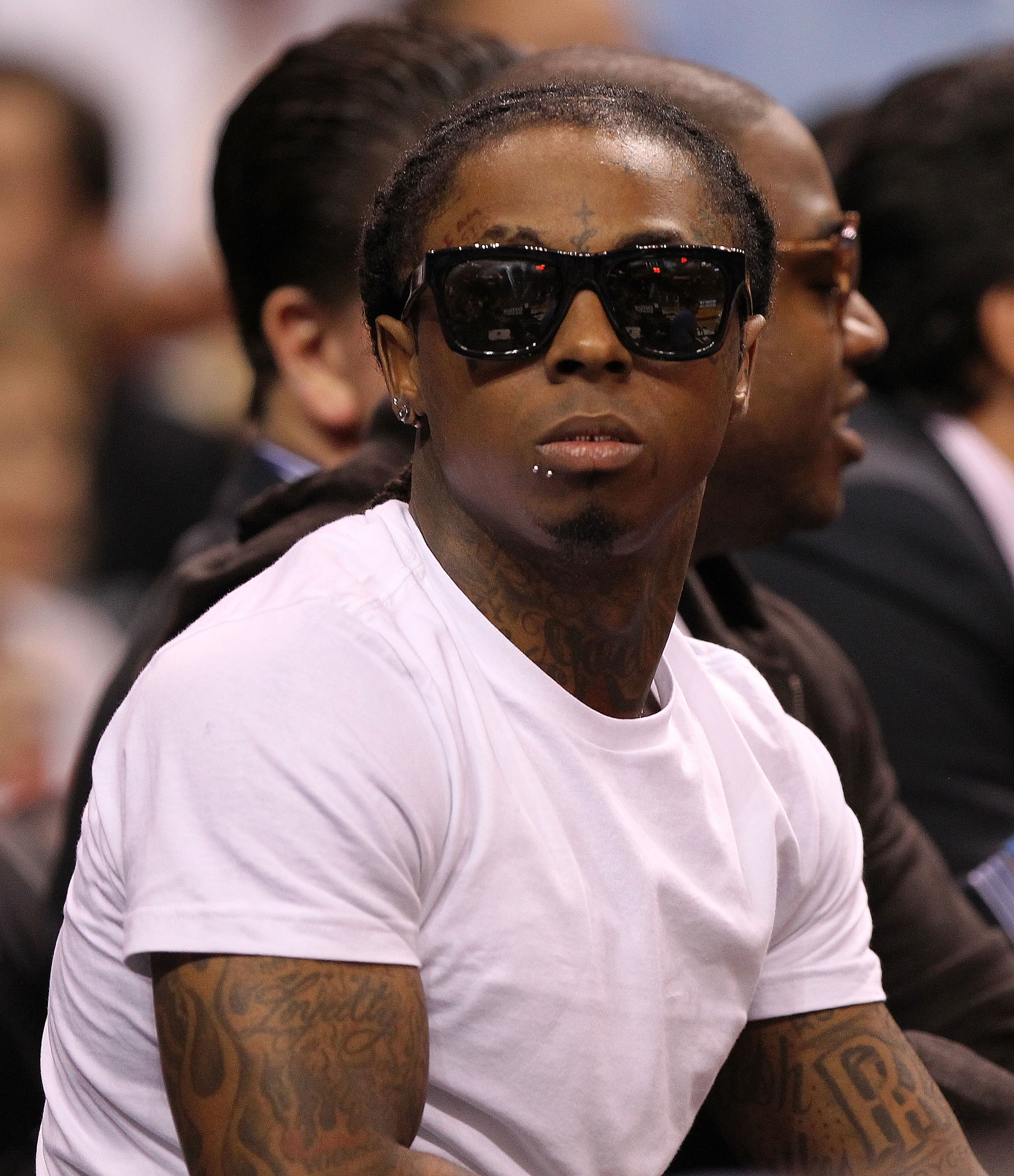 MIAMI, FL - JANUARY 04: Rapper Lil' Wayne watches a game between the Miami Heat and the Milwaukee Bucks at American Airlines Arena on January 4, 2011 in Miami, Florida. NOTE TO USER: User expressly acknowledges and agrees that, by downloading and/or using