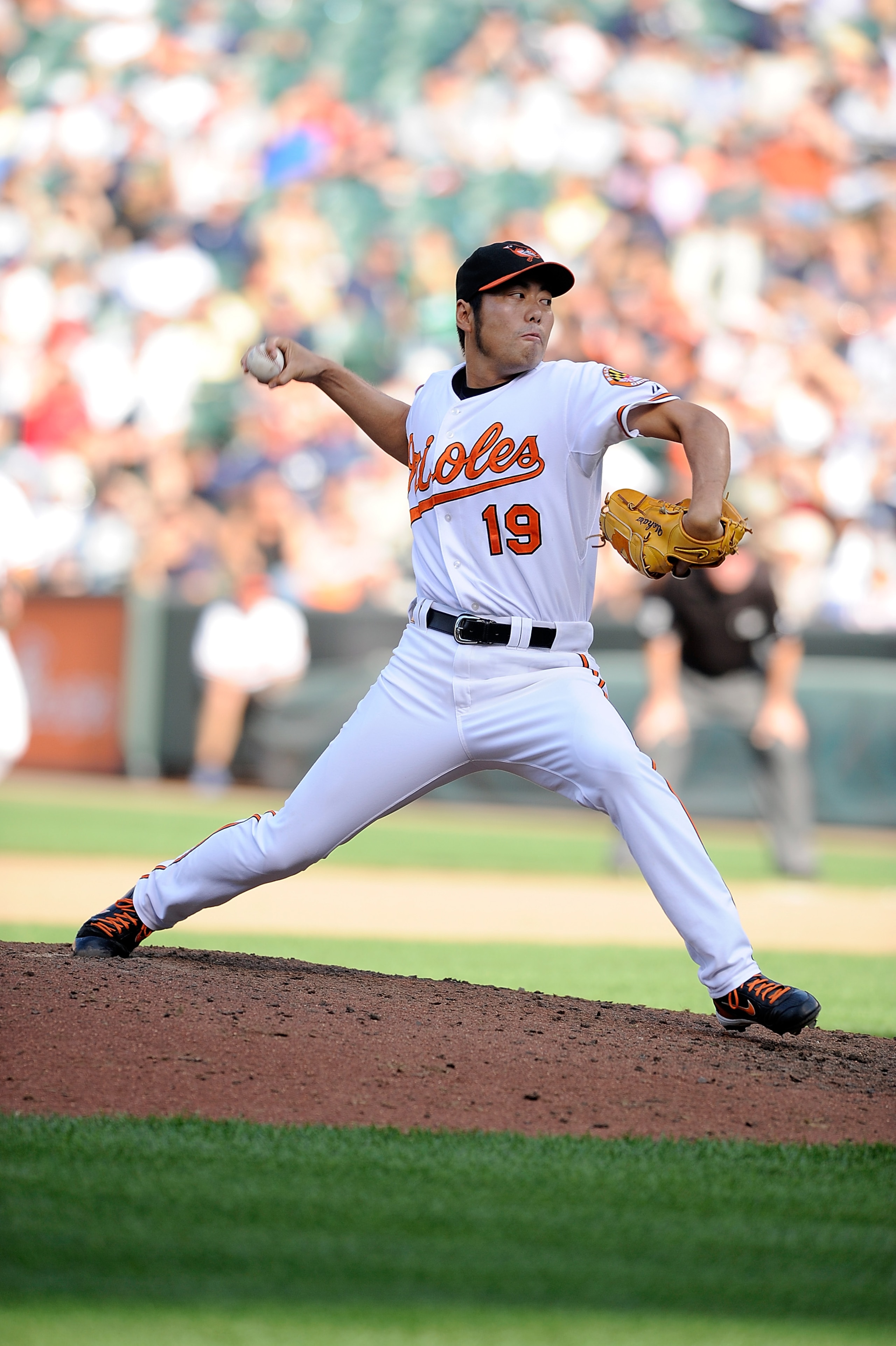 BALTIMORE - SEPTEMBER 19:  Koji Uehara #19 of the Baltimore Orioles pitches against the New York Yankees at Camden Yards on September 19, 2010 in Baltimore, Maryland.  (Photo by Greg Fiume/Getty Images)