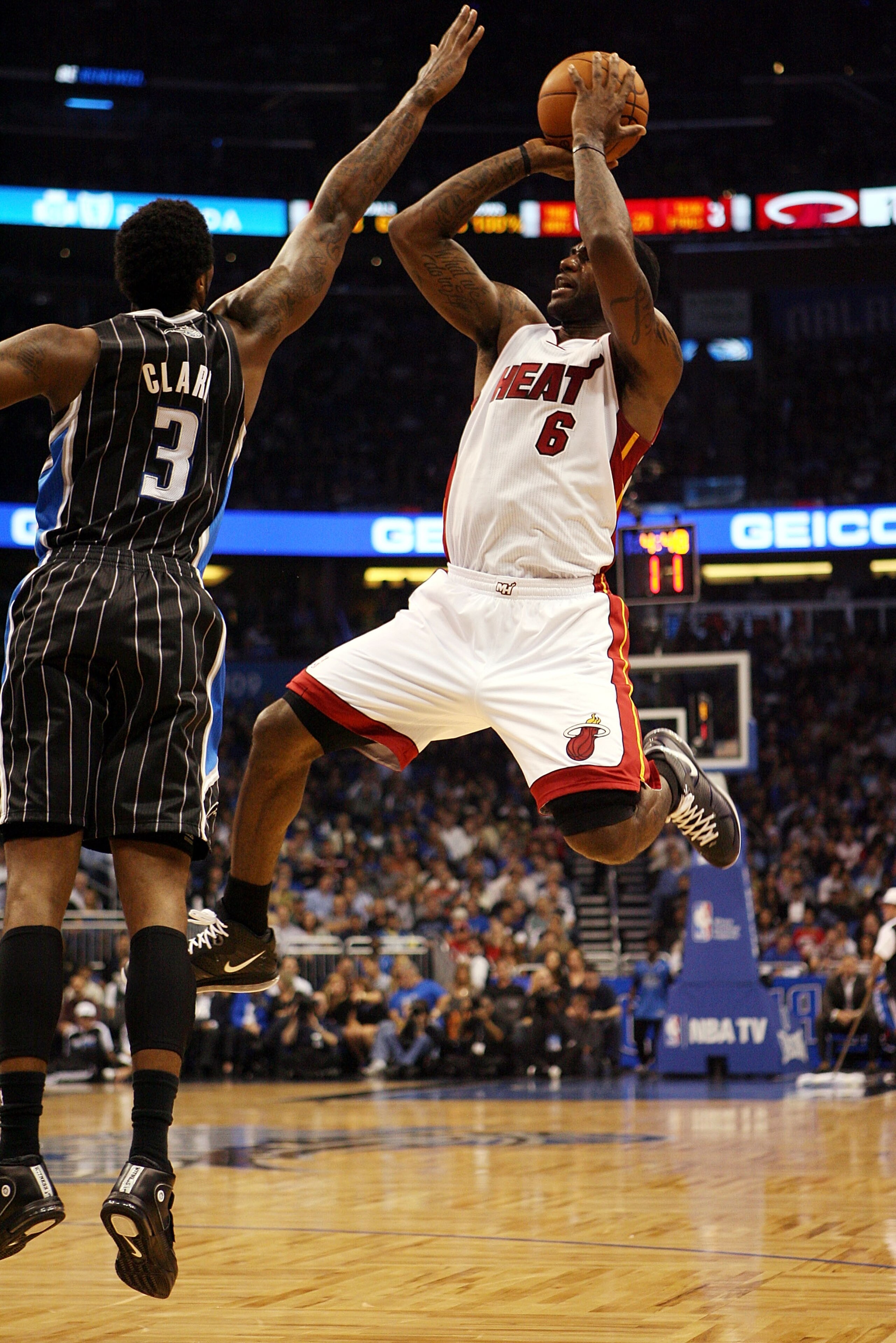 ORLANDO, FL - FEBRUARY 03: Forward LeBron James #6 of the Miami Heat shoots over Forward Earl Clark #3 of the Orlando Magic at Amway Arena on February 3, 2011 in Orlando, Florida. NOTE TO USER: User expressly acknowledges and agrees that, by downloading a