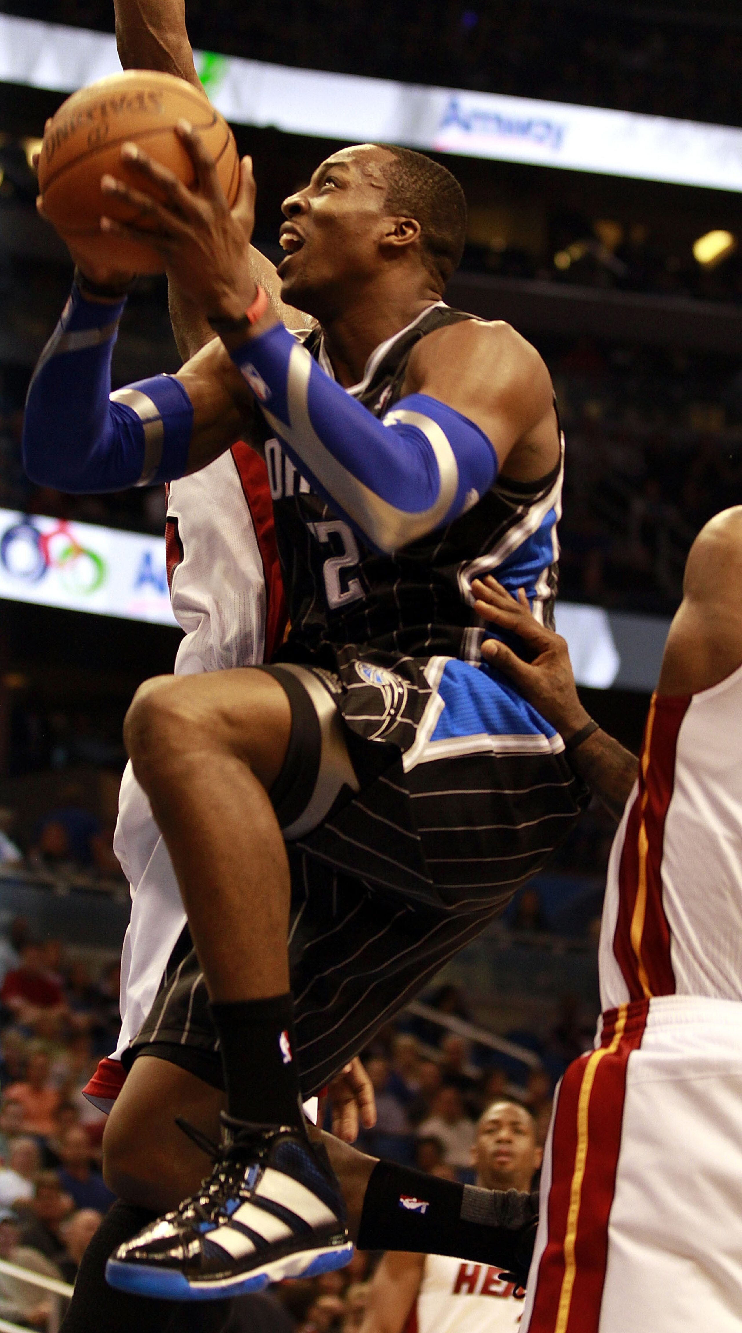 ORLANDO, FL - FEBRUARY 03:  Center Dwight Howard #12 of the Orlando Magic drives against the Miami Heat at Amway Arena on February 3, 2011 in Orlando, Florida. NOTE TO USER: User expressly acknowledges and agrees that, by downloading and or using this pho