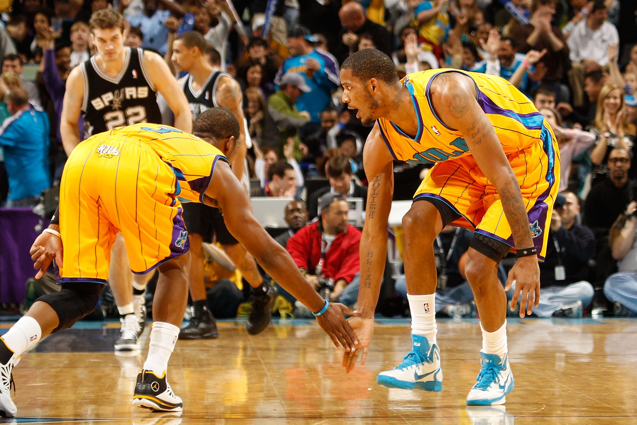 NEW ORLEANS, LA - JANUARY 22:  Chris Paul #3 and Trevor Ariza #1 of the New Orleans Hornets celebrate during the game against the San Antonio Spurs at the New Orleans Arena on January 22, 2011 in New Orleans, Louisiana.  The Hornets defeated the Spurs 96-