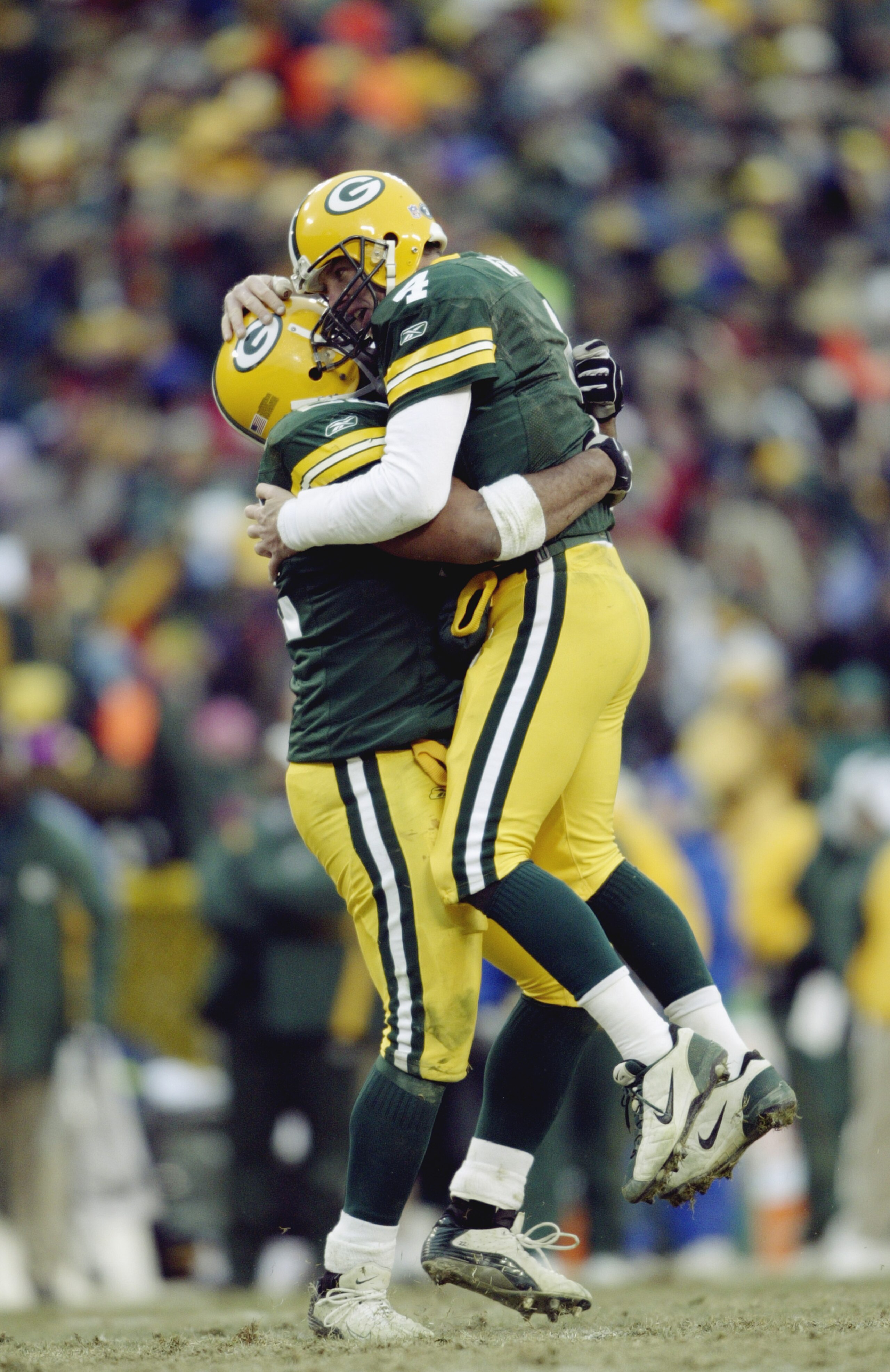 GREEN BAY, WI - JANUARY 4: Quarterback Brett Favre #4 and fullback Nick Luchey #22 of the Green Bay Packers hug during the NFC playoff game against the Seattle Seahawks on January 4, 2004 in Lambeau Field in Green Bay, Wisconsin. The Packers defeated the