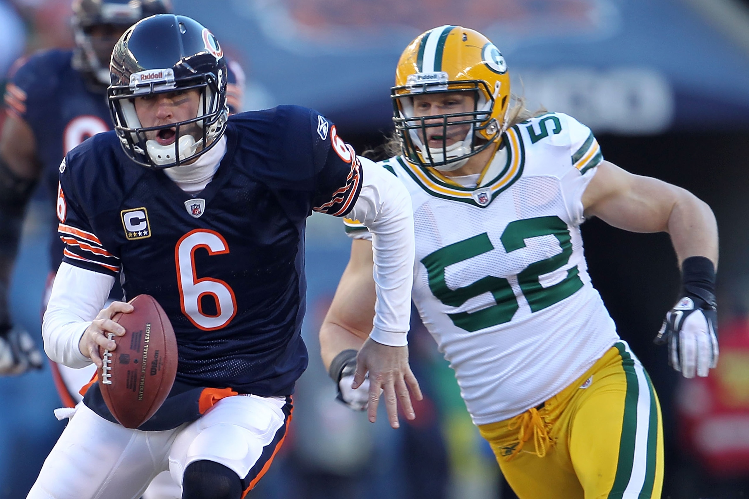 CHICAGO, IL - JANUARY 23:  Quarterback Jay Cutler #6 of the Chicago Bears runs the ball ahead of Clay Matthews #52 of the Green Bay Packers in the second quarter of the NFC Championship Game at Soldier Field on January 23, 2011 in Chicago, Illinois.  (Pho
