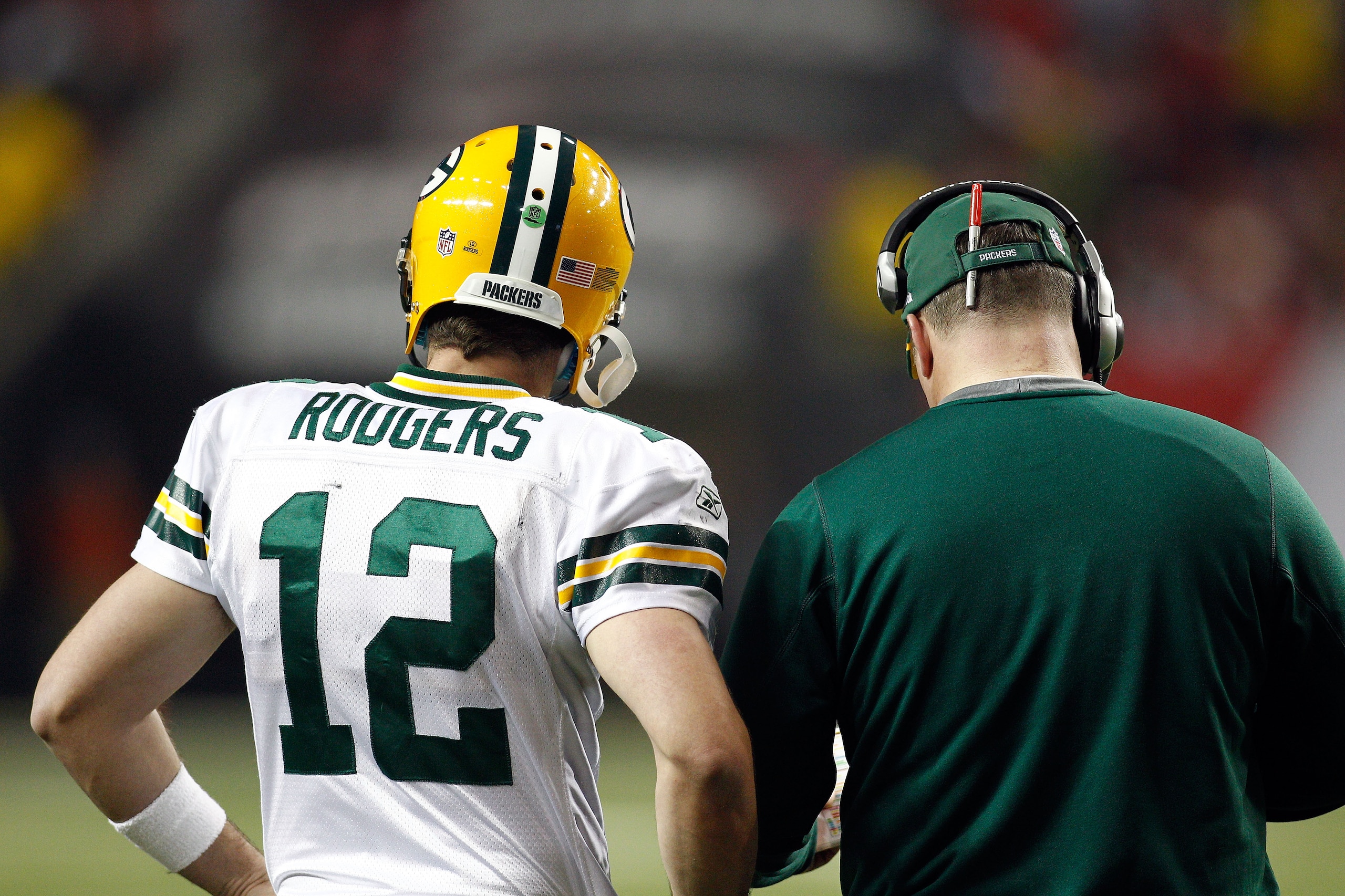 ATLANTA, GA - JANUARY 15:  (L-R) Quarterback Aaron Rodgers #12 and head coach Mike McCarthy of the Green Bay Packers talk on the sideline against the Atlanta Falcons during their 2011 NFC divisional playoff game at Georgia Dome on January 15, 2011 in Atla