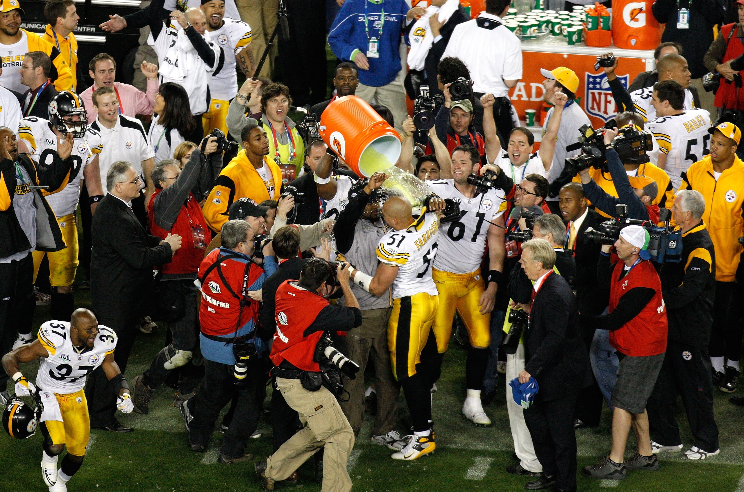 TAMPA, FL - FEBRUARY 01:  James Harrison #92 of the Pittsburgh Steelers pours Gatorade over head coach Mike Tomlin and James Farrior #51 after the Steelers won 27-23 against the Arizona Cardinals during Super Bowl XLIII on February 1, 2009 at Raymond Jame