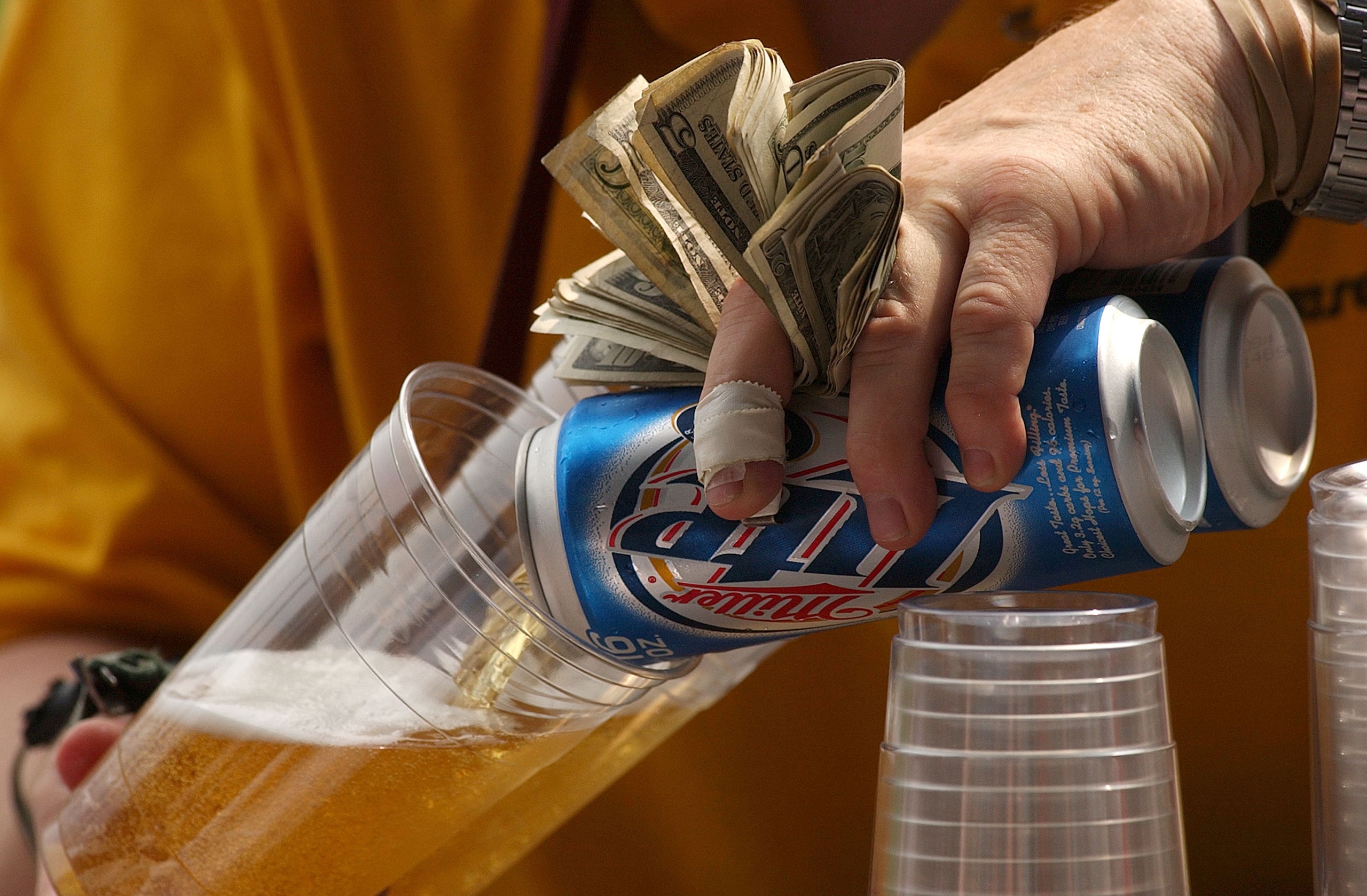 CHICAGO - SEPTEMBER 5:  A vendor pours beer for fans during a game between the Chicago White Sox and the Seattle Mariners on September 5, 2004 at U.S. Cellular Field in Chicago, Illinois. The White Sox defeated the Mariners 6-2.  (Photo by Jonathan Daniel