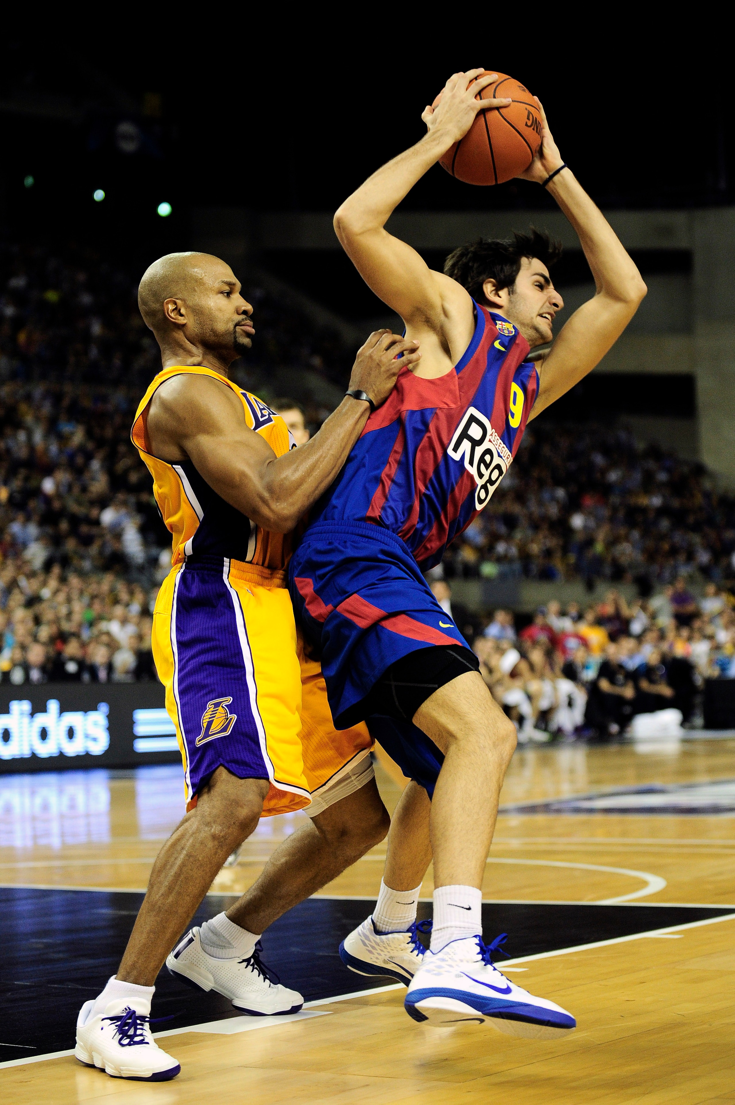 BARCELONA, SPAIN - OCTOBER 07:  Ricky Rubio (R) #9 of the FC Barcelona duels  for a ball against Derek Fisher #2 of the Los Angeles Lakers during the NBA Europe Live match between Los Angeles Lakers and Regal FC Barcelona at the at Palau Blaugrana on Octo
