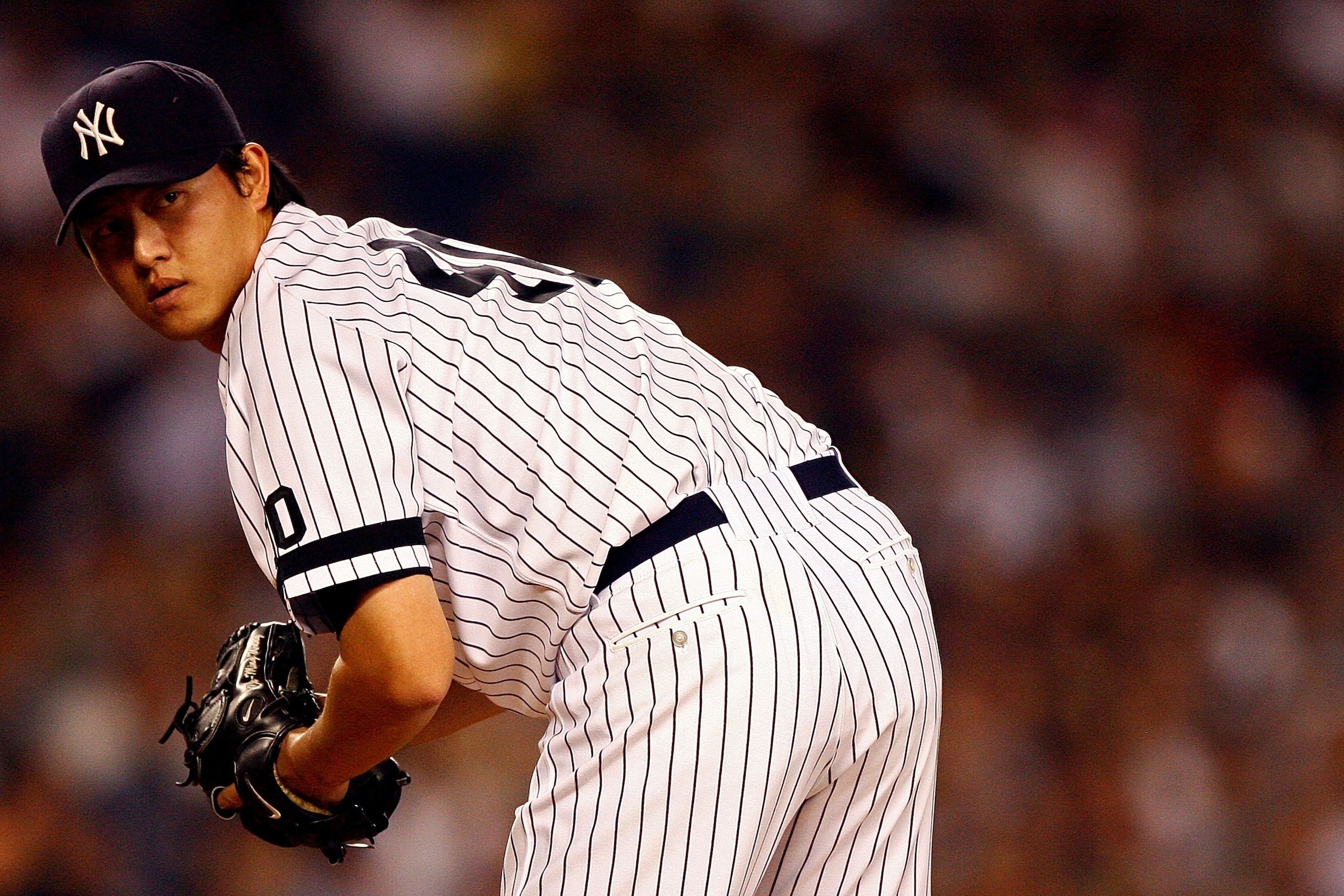 NEW YORK - OCTOBER 08: Starting pitcher Chien-Ming Wang #40 of the New York Yankees looks to first against the Cleveland Indians during Game Four of the American League Division Series at Yankee Stadium on October 8, 2007 in the Bronx borough of New York NEW YORK - OCTOBER 08: Starting pitcher Chien-Ming Wang #40 of the New York Yankees looks to first against the Cleveland Indians during Game Four of the American League Division Series at Yankee Stadium on October 8, 2007 in the Bronx borough of New York