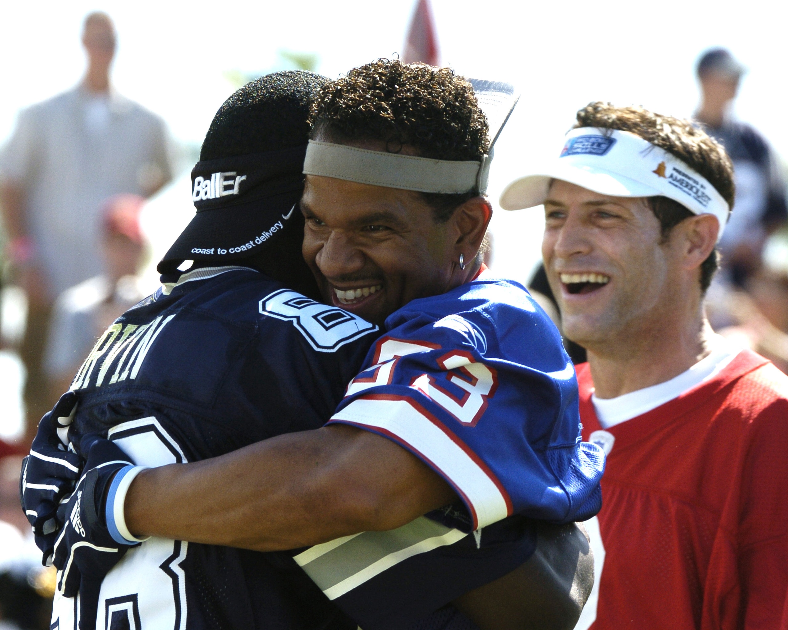 Buffalo Bills wide receiver Andre Reed hugs Dallas Cowboys wide receiver Michael Irvin during  a flag-football legends  game during 2005 Pro Bowl week in Ko Olina, Honolulu February 11, 2005.  (Photo by Al Messerschmidt/Getty Images)