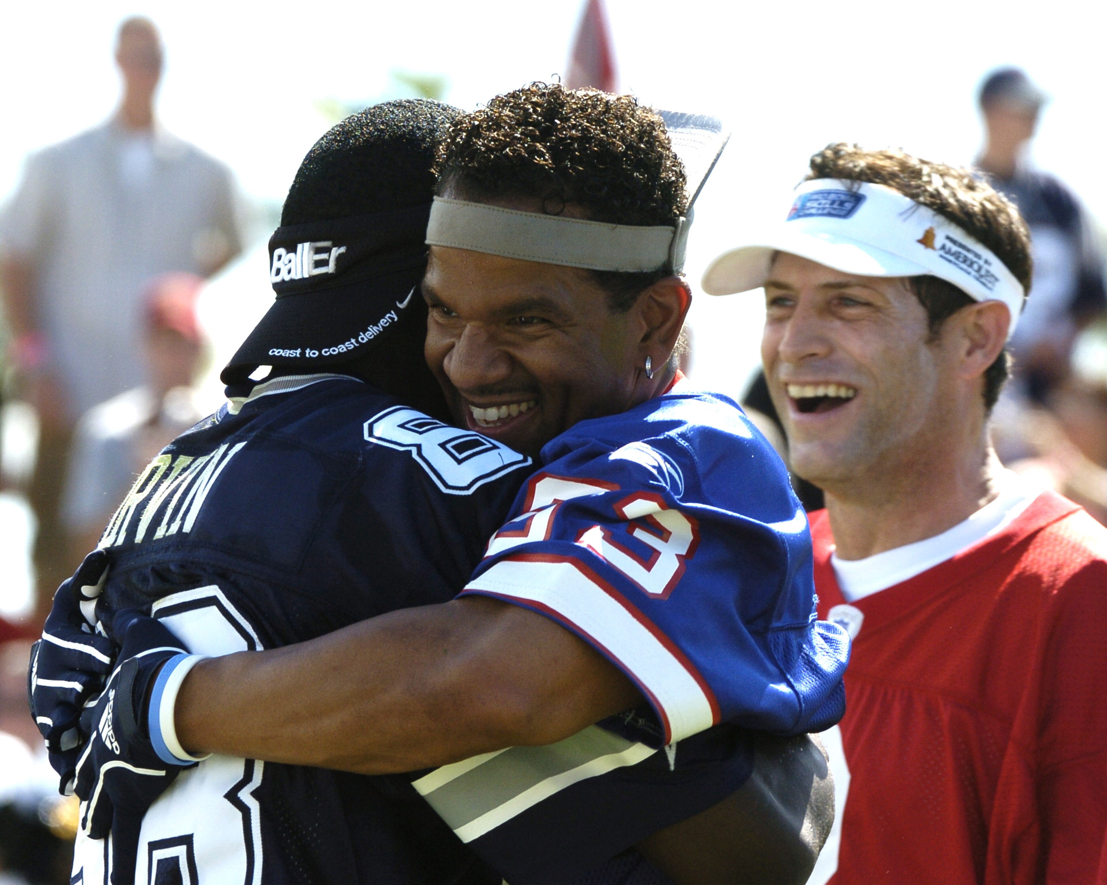 Buffalo Bills wide receiver Andre Reed hugs Dallas Cowboys wide receiver Michael Irvin during  a flag-football legends  game during 2005 Pro Bowl week in Ko Olina, Honolulu February 11, 2005.  (Photo by Al Messerschmidt/Getty Images)