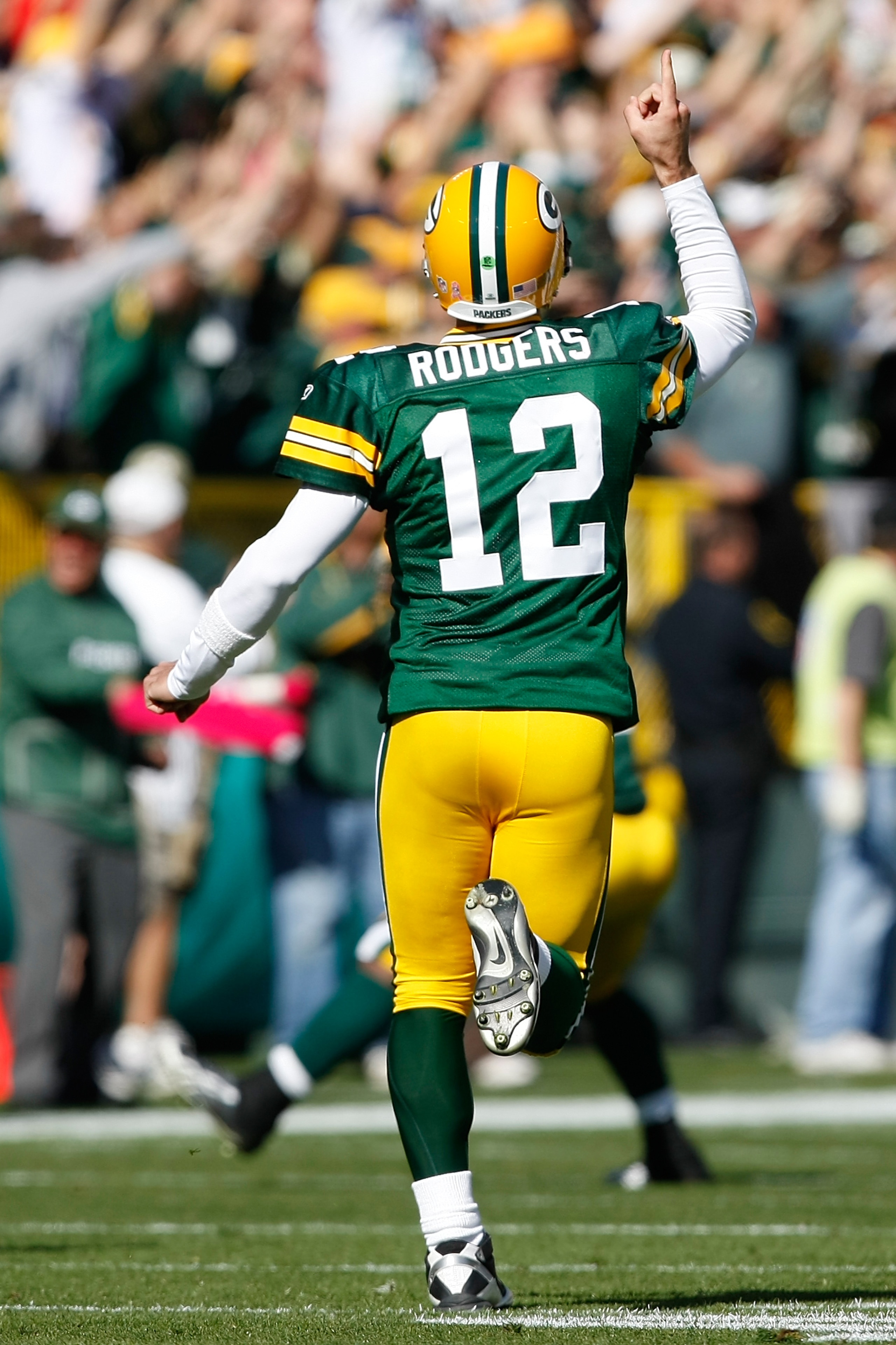 GREEN BAY, WI - OCTOBER 17: Aaron Rogers #12 of the Green Bay Packers celebrates a touchdown pass against the Miami Dolphins at Lambeau Field on October 17, 2010 in Green Bay, Wisconsin. (Photo by Scott Boehm/Getty Images)
