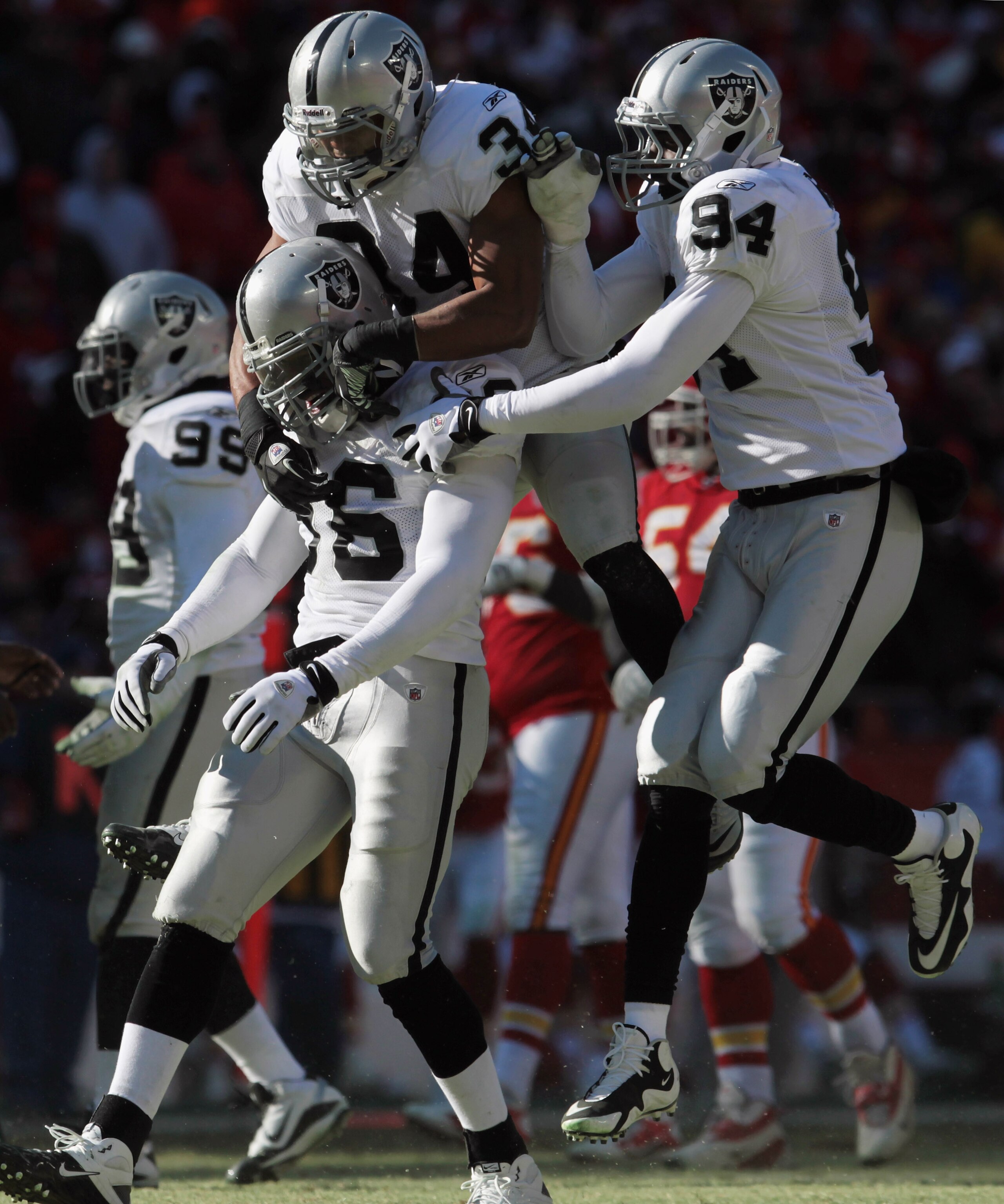 KANSAS CITY, MO - JANUARY 02: Oakland Raiders defensive players celebrate after stopping the Kansas City Chiefs during the game on January 2, 2011 at Arrowhead Stadium in Kansas City, Missouri.  (Photo by Jamie Squire/Getty Images)
