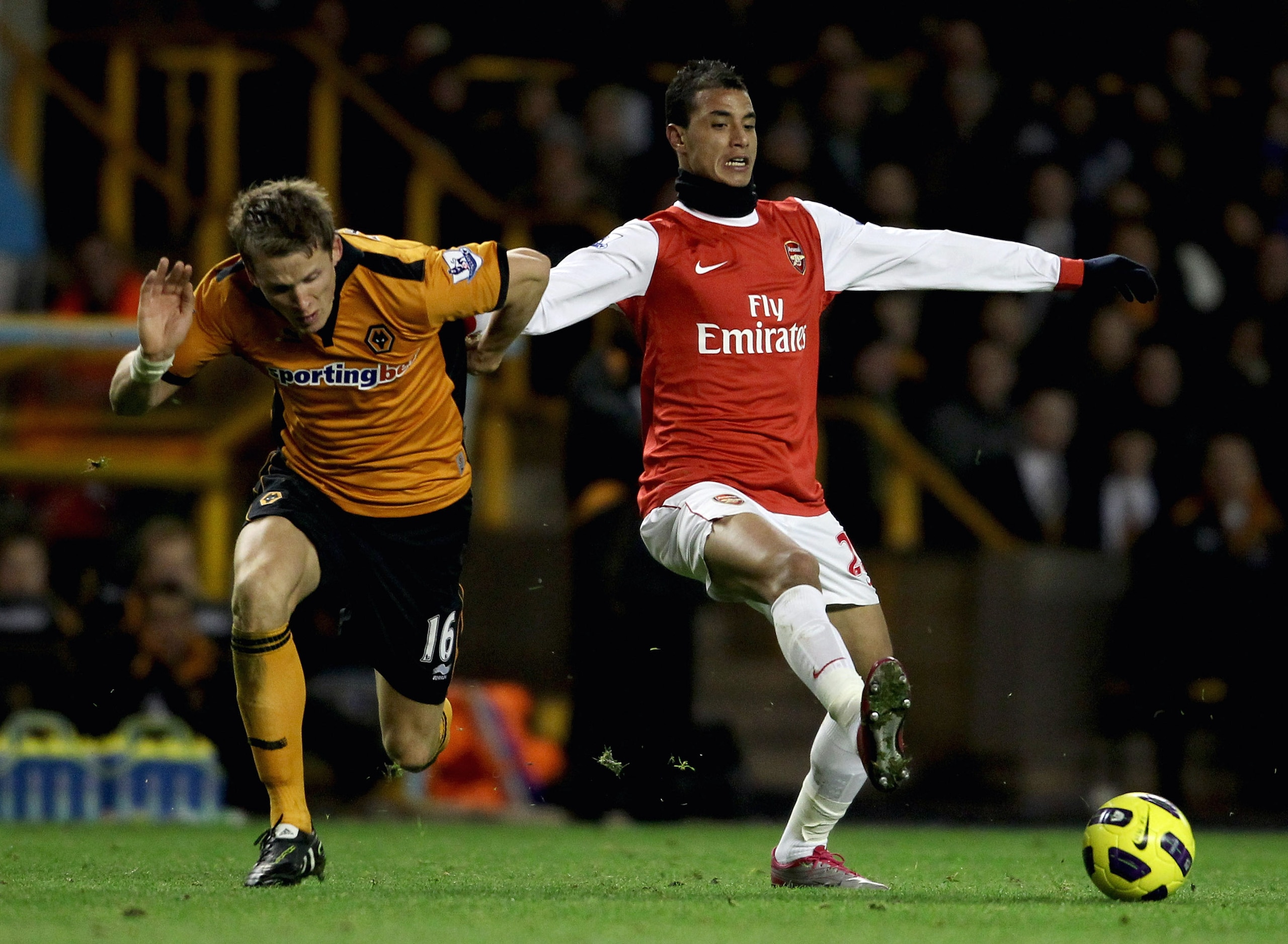 WOLVERHAMPTON, ENGLAND - NOVEMBER 10: Marouane Chamakh of Arsenal (R) in action with Christophe Berra of Wolverhampton during the Barclays Premier League match between Wolverhampton Wanderers and Arsenal, at Molineux on November 10, 2010 in Wolverhampto WOLVERHAMPTON, ENGLAND - NOVEMBER 10: Marouane Chamakh of Arsenal (R) in action with Christophe Berra of Wolverhampton during the Barclays Premier League match between Wolverhampton Wanderers and Arsenal, at Molineux on November 10, 2010 in Wolverhampto