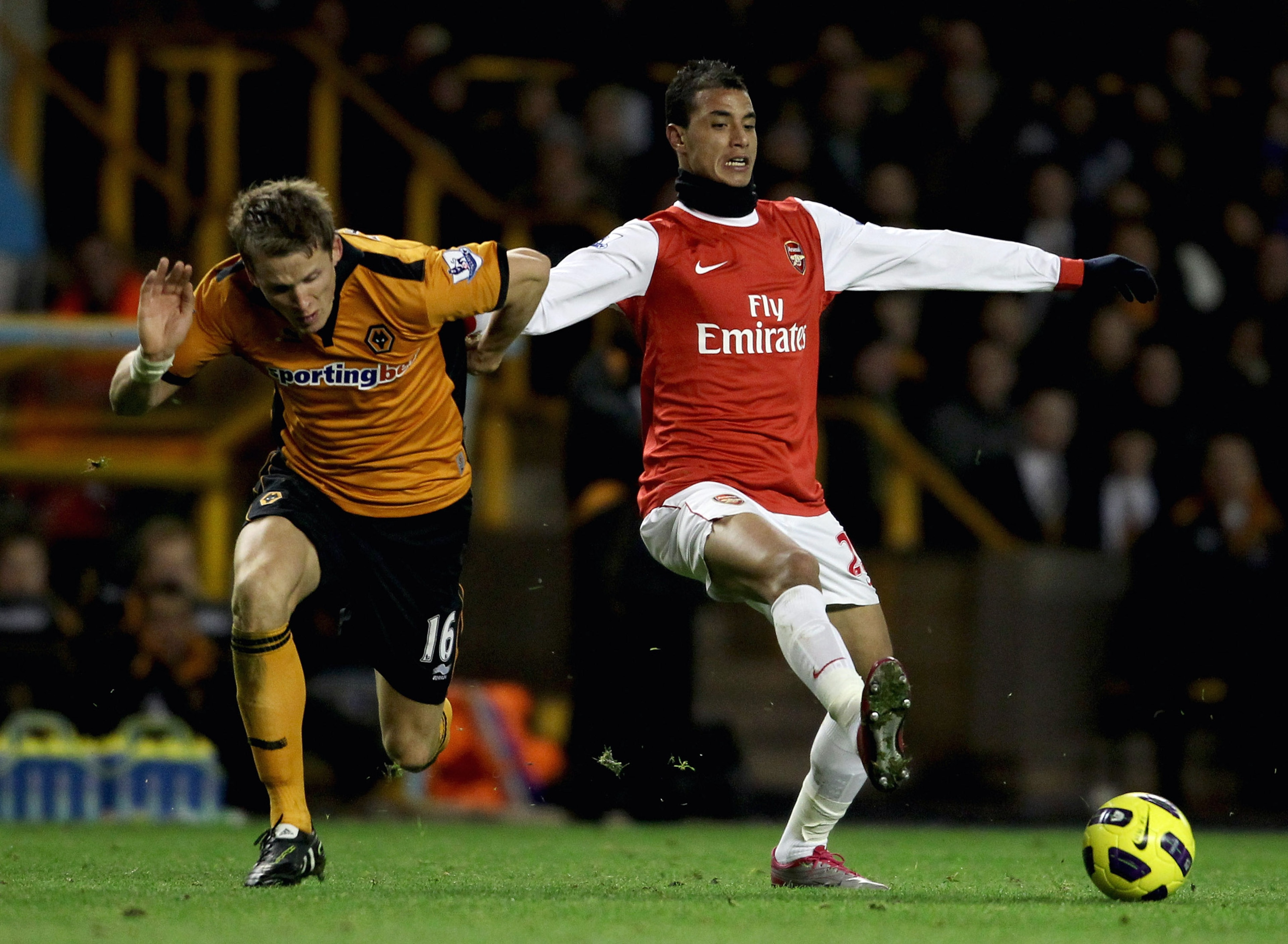 WOLVERHAMPTON, ENGLAND - NOVEMBER 10:  Marouane Chamakh of Arsenal (R) in action with Christophe Berra of Wolverhampton during the Barclays Premier League match between Wolverhampton Wanderers and Arsenal, at Molineux  on November 10, 2010 in Wolverhampto