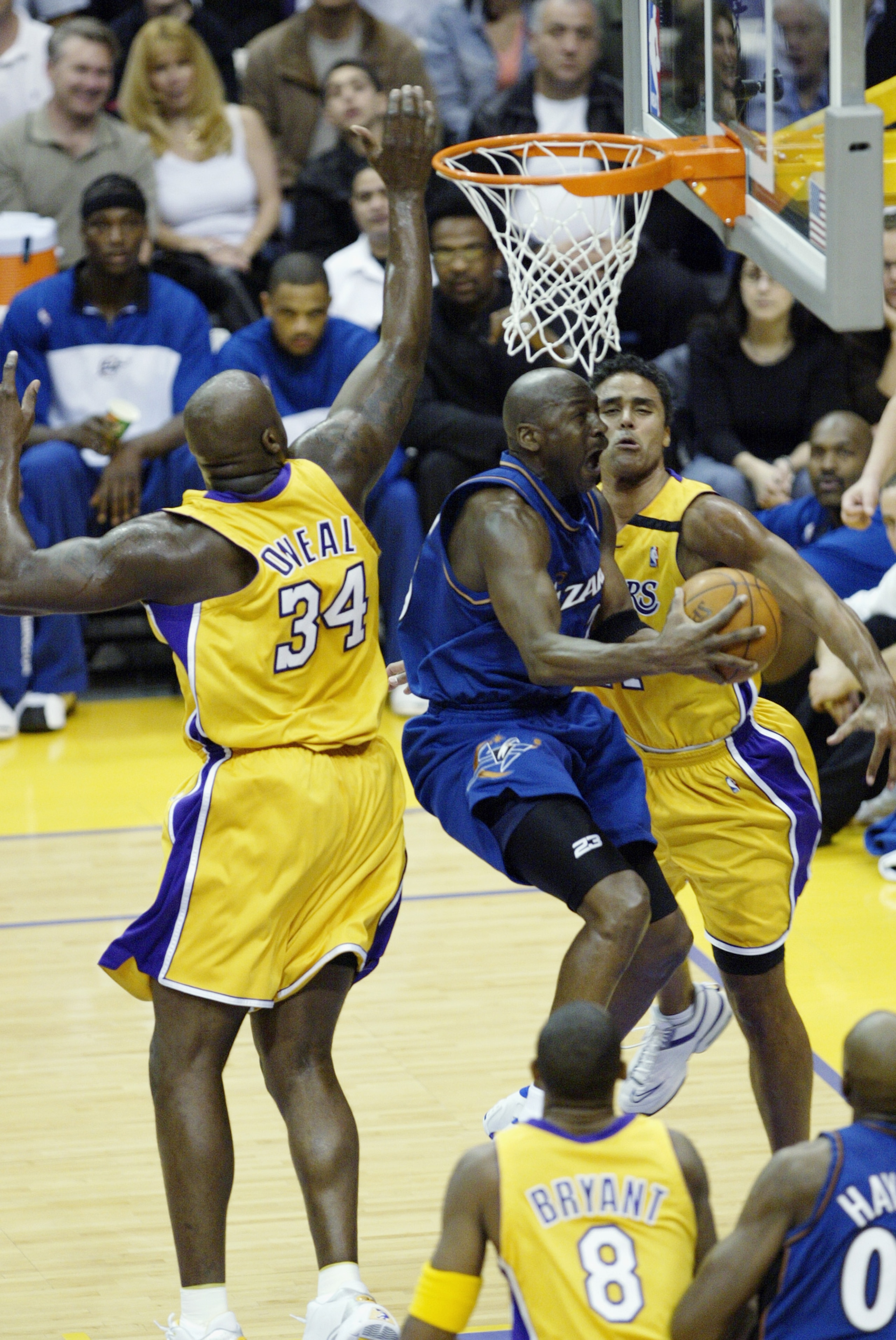 LOS ANGELES - MARCH 28:  Michael Jordan #23 of the Washington Wizards drives to the basket past Shaquille O'Neal #34 of the Los Angeles Lakers during the game at Staples Center on March 28, 2003 in Los Angeles, California.  The Lakers won 108-94.  NOTE TO