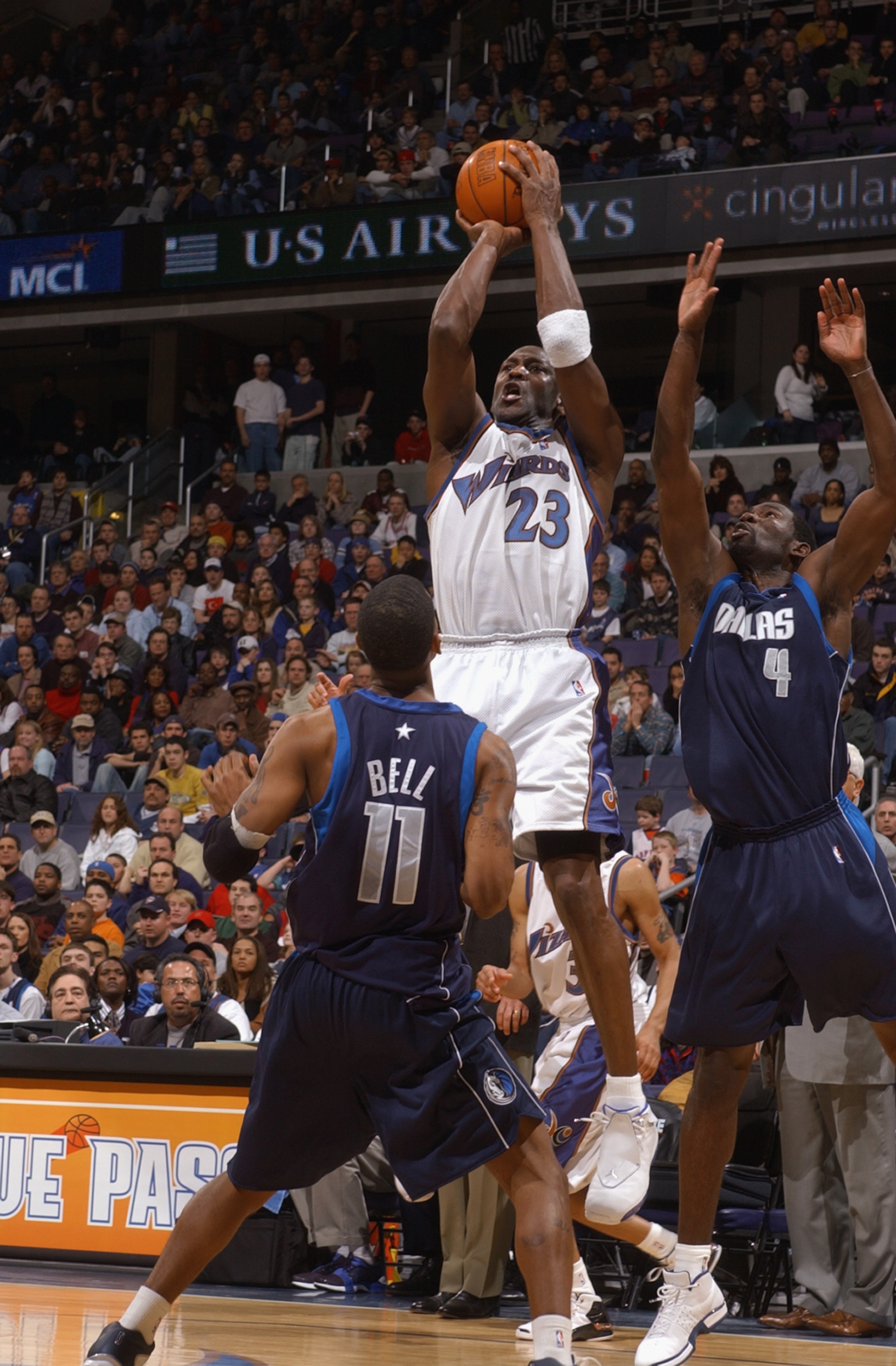 WASHINGTON - FEBRUARY 23:  Michael Jordan #23 of the Washington Wizards shoots against Raja Bell #11 and Michael Finley #4 of the Dallas Mavericks during the NBA game at MCI Center on February 23, 2003 in Washington, D.C.  The Mavericks won in overtime 10