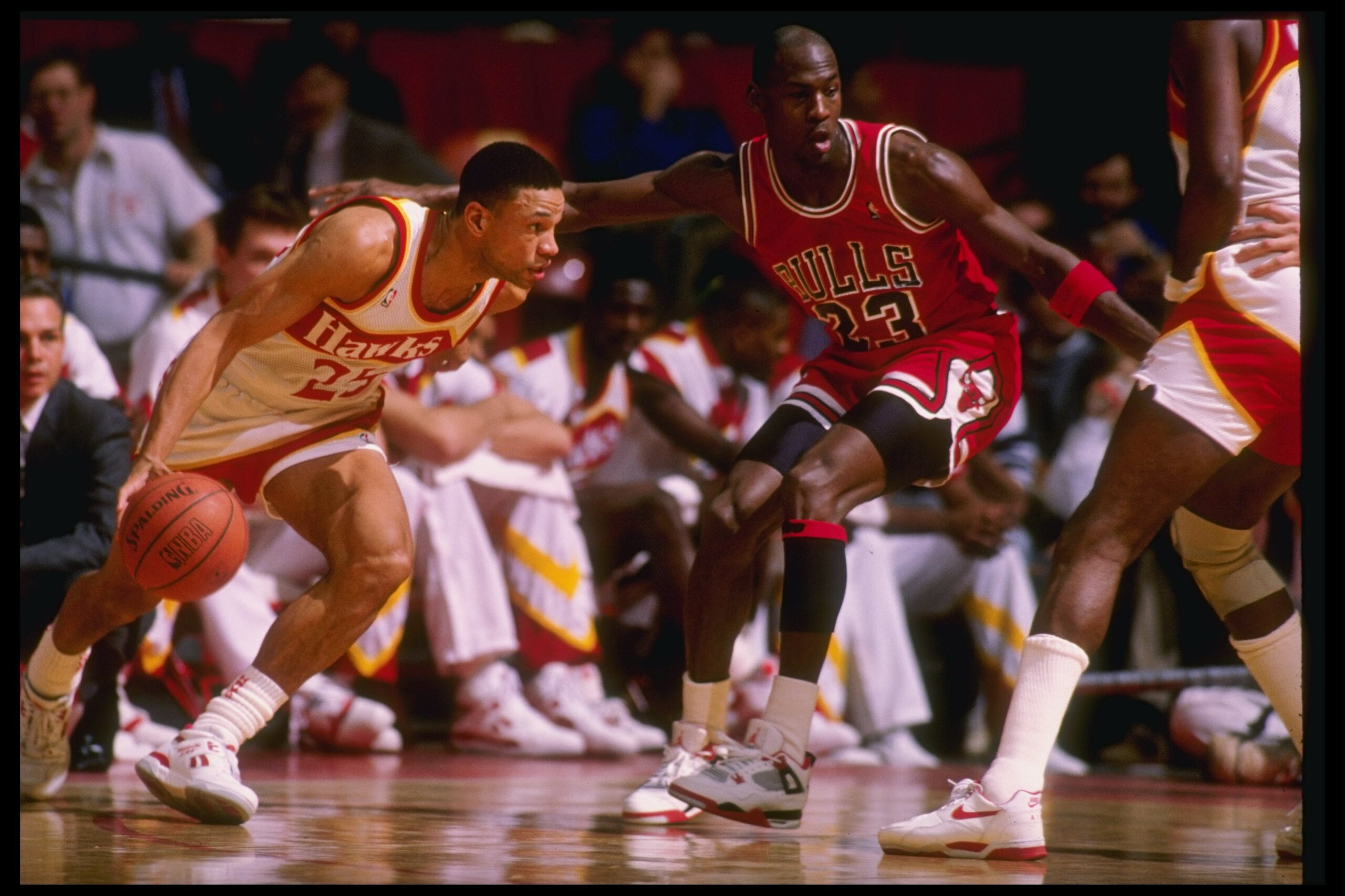 Guard Doc Rivers of the Atlanta Hawks tries to fend off guard Michael Jordan of the Chicago Bulls during a game at the Omni in Atlanta, Georgia.