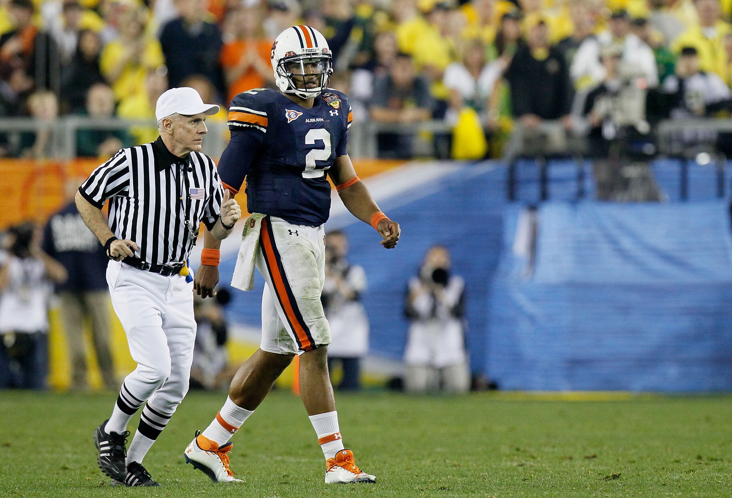 GLENDALE, AZ - JANUARY 10: Cameron Newton #2 of the Auburn Tigers looks on as an official runs past during their game against the Oregon Ducks during the Tostitos BCS National Championship Game at University of Phoenix Stadium on January 10, 2011 in Glen GLENDALE, AZ - JANUARY 10: Cameron Newton #2 of the Auburn Tigers looks on as an official runs past during their game against the Oregon Ducks during the Tostitos BCS National Championship Game at University of Phoenix Stadium on January 10, 2011 in Glen