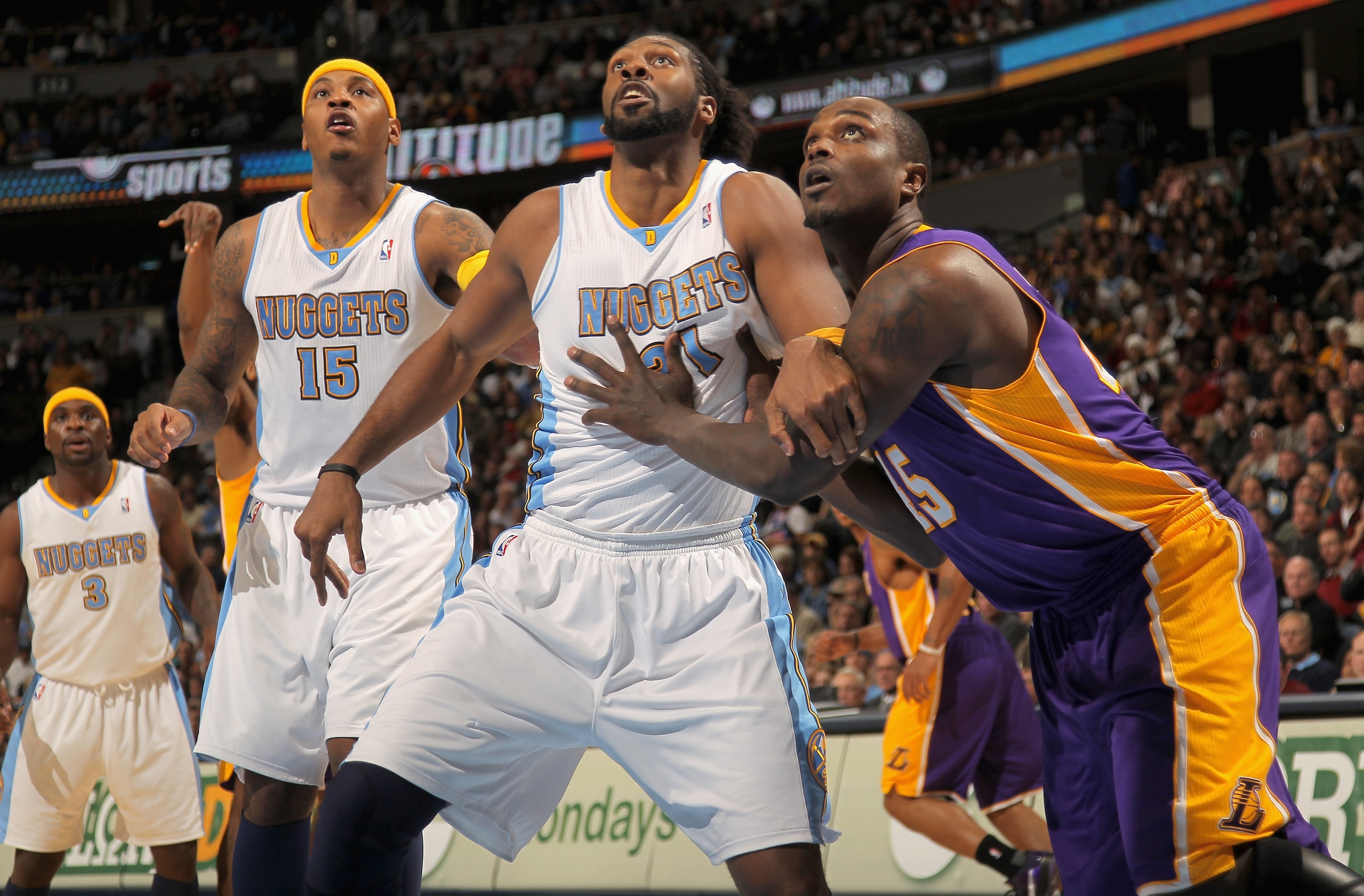 DENVER - NOVEMBER 11:  Carmelo Anthony #15 and Nene #31 of the Denver Nuggets and Derrick Caracter #45 of the Los Angeles Lakers vie for rebounding position at the Pepsi Center on November 11, 2010 in Denver, Colorado. The Nuggets defeated the Lakers 118-