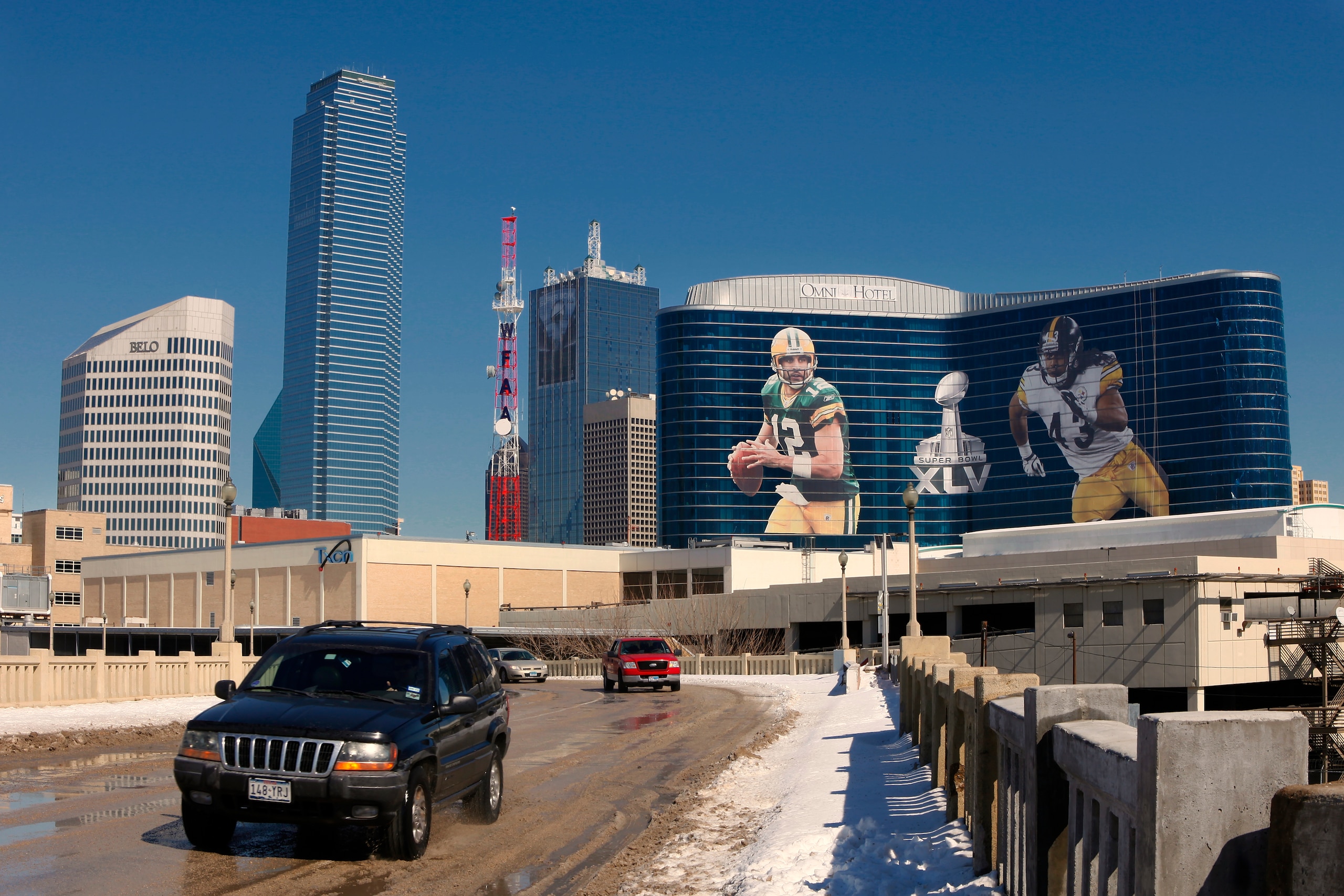 DALLAS, TX - FEBRUARY 5: General view of the downtown skyline with Super Bowl XLV art draped from the Omni Hotel as motorists make their way along on February 5, 2011 in Dallas, Texas. The Green Bay Packers will play the Pittsburgh Steelers in Super Bowl