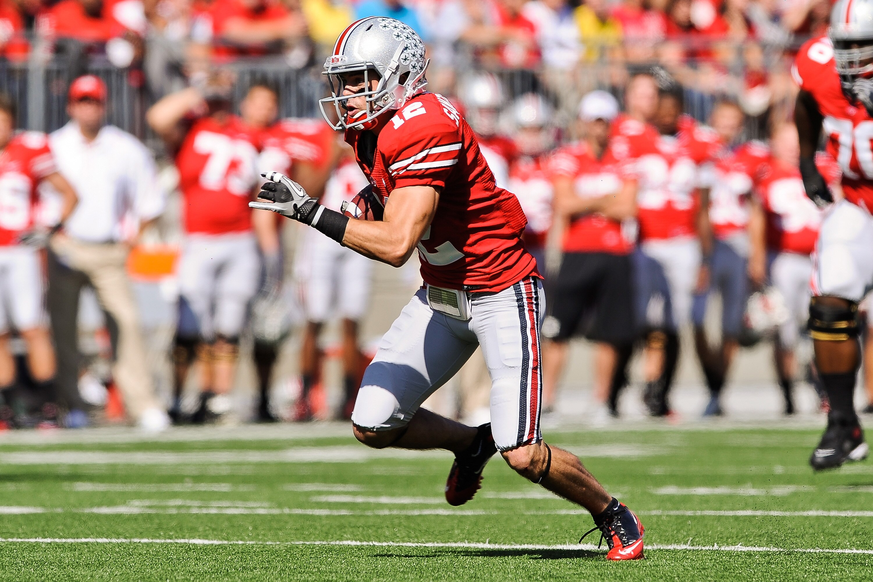 COLUMBUS, OH - OCTOBER 9:  Dane Sanzenbacher #12 of the Ohio State Buckeyes runs with the ball against the Indiana Hoosiers at Ohio Stadium on October 9, 2010 in Columbus, Ohio.  (Photo by Jamie Sabau/Getty Images)