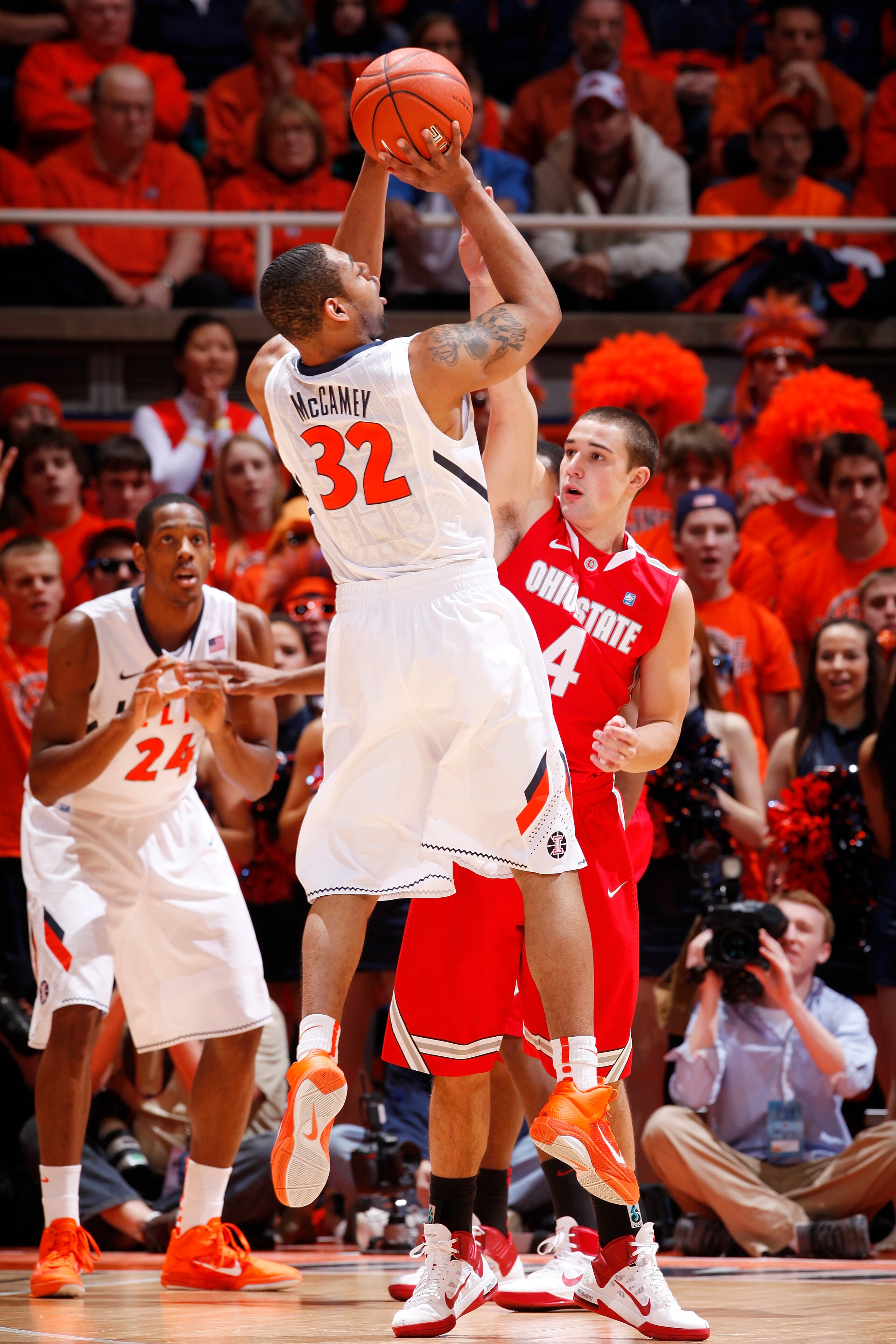 CHAMPAIGN, IL - JANUARY 22: Demetri McCamey #32 of the Illinois Fighting Illini takes a shot while being defended by Aaron Craft #4 of the Ohio State Buckeyes at Assembly Hall on January 22, 2011 in Champaign, Illinois. Ohio State won 73-68. (Photo by Joe