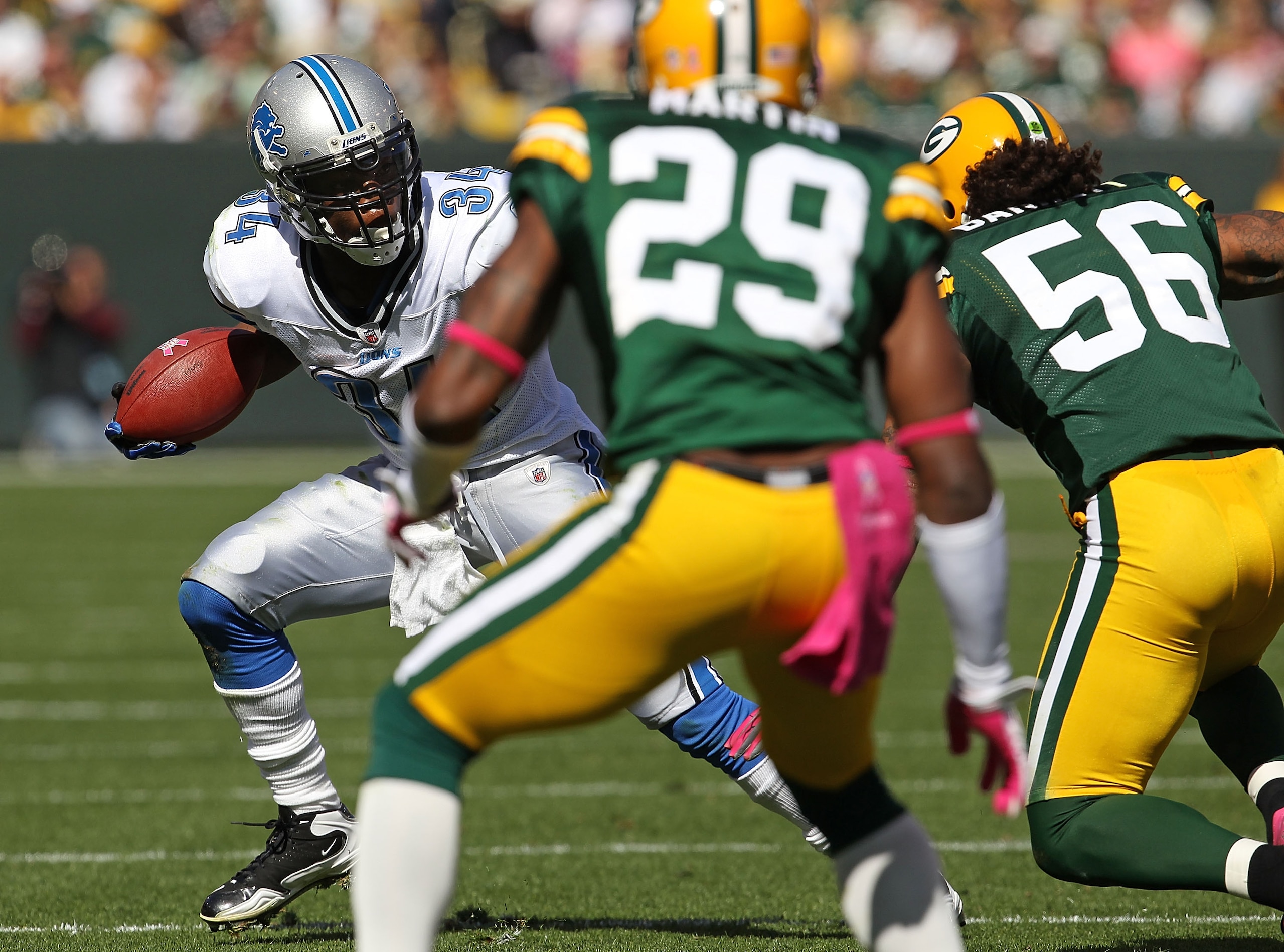 GREEN BAY, WI - OCTOBER 03: Kevin Smith #34 of the Detroit Lions tries to run against Nick Barnett #56 and Derrick Martin #29 of the Green Bay Packers at Lambeau Field on October 3, 2010 in Green Bay, Wisconsin. The Packers defeated the Lions 28-26.  (Pho