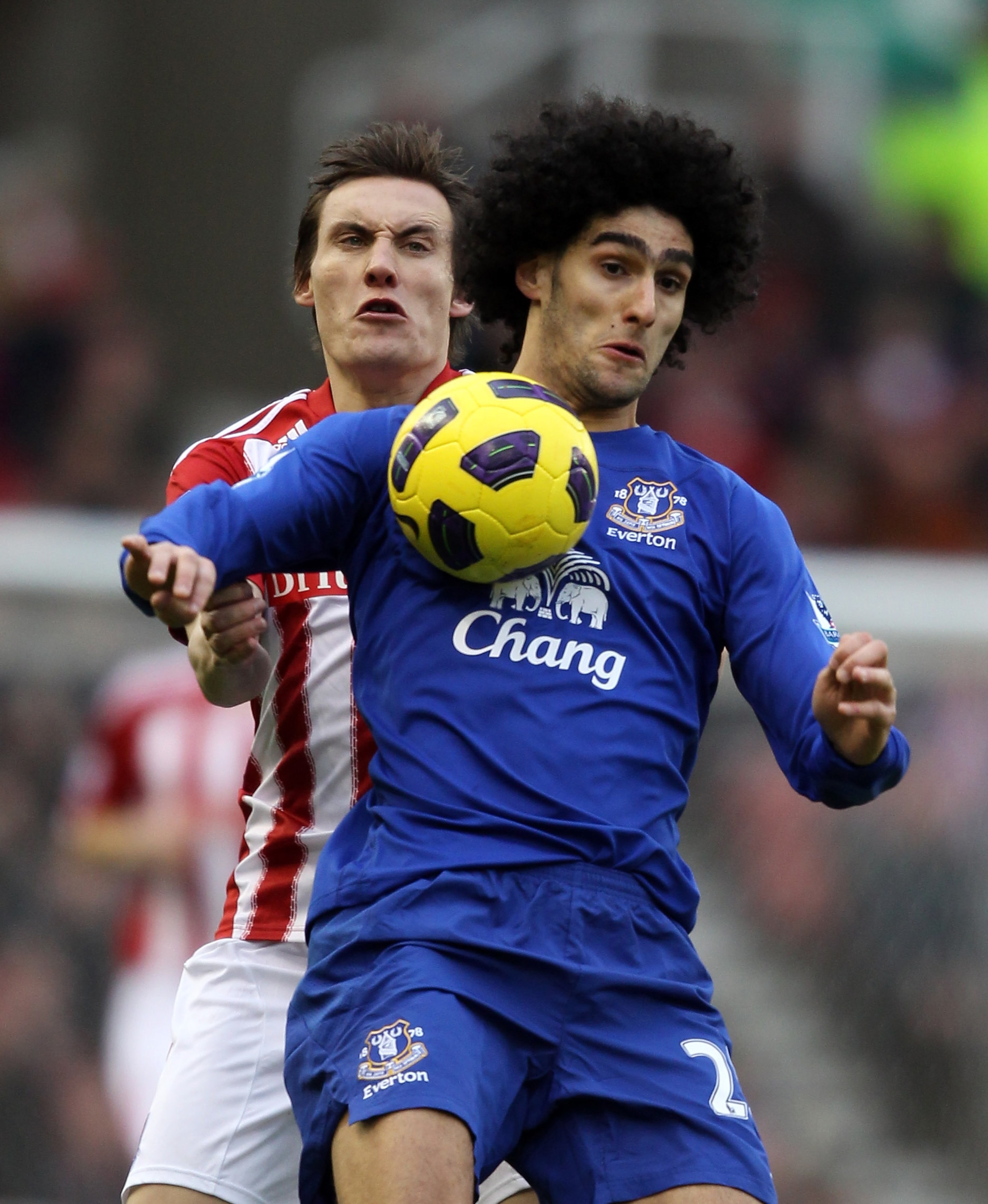 STOKE ON TRENT, ENGLAND - JANUARY 01:  Dean Whitehead of Stoke is challenged by Marouane Fellaini of Everton during the Barclays Premier League match between Stoke City and Everton at the Britannia Stadium on January 1, 2011 in Stoke on Trent, England.  (