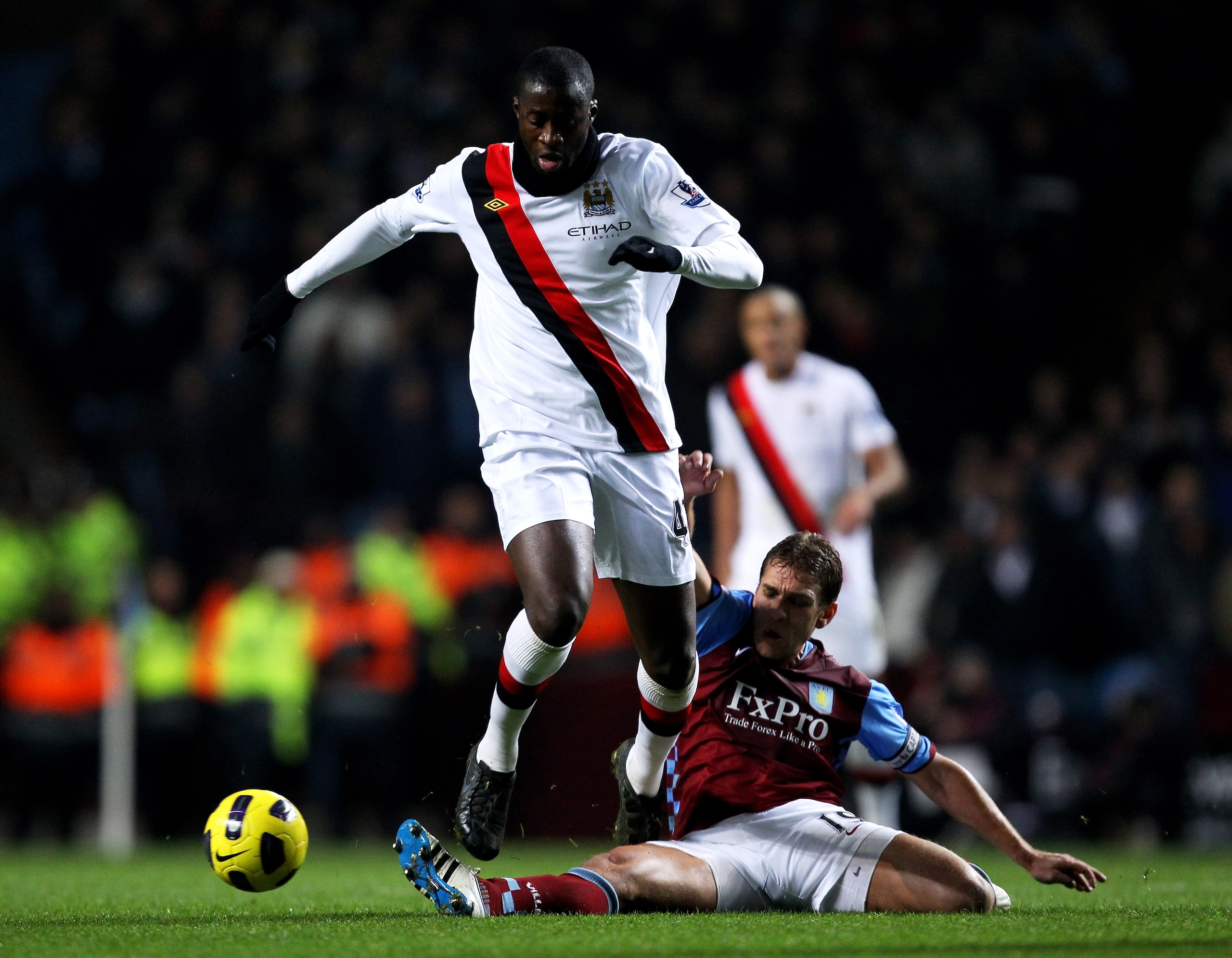 BIRMINGHAM, ENGLAND - JANUARY 22:  Yaya Toure of Manchester City is tackled by Stiliyan Petrov of Aston Villa during the Barclays Premier League match between Aston Villa and Manchester City at Villa Park on January 22, 2011 in Birmingham, England.  (Phot