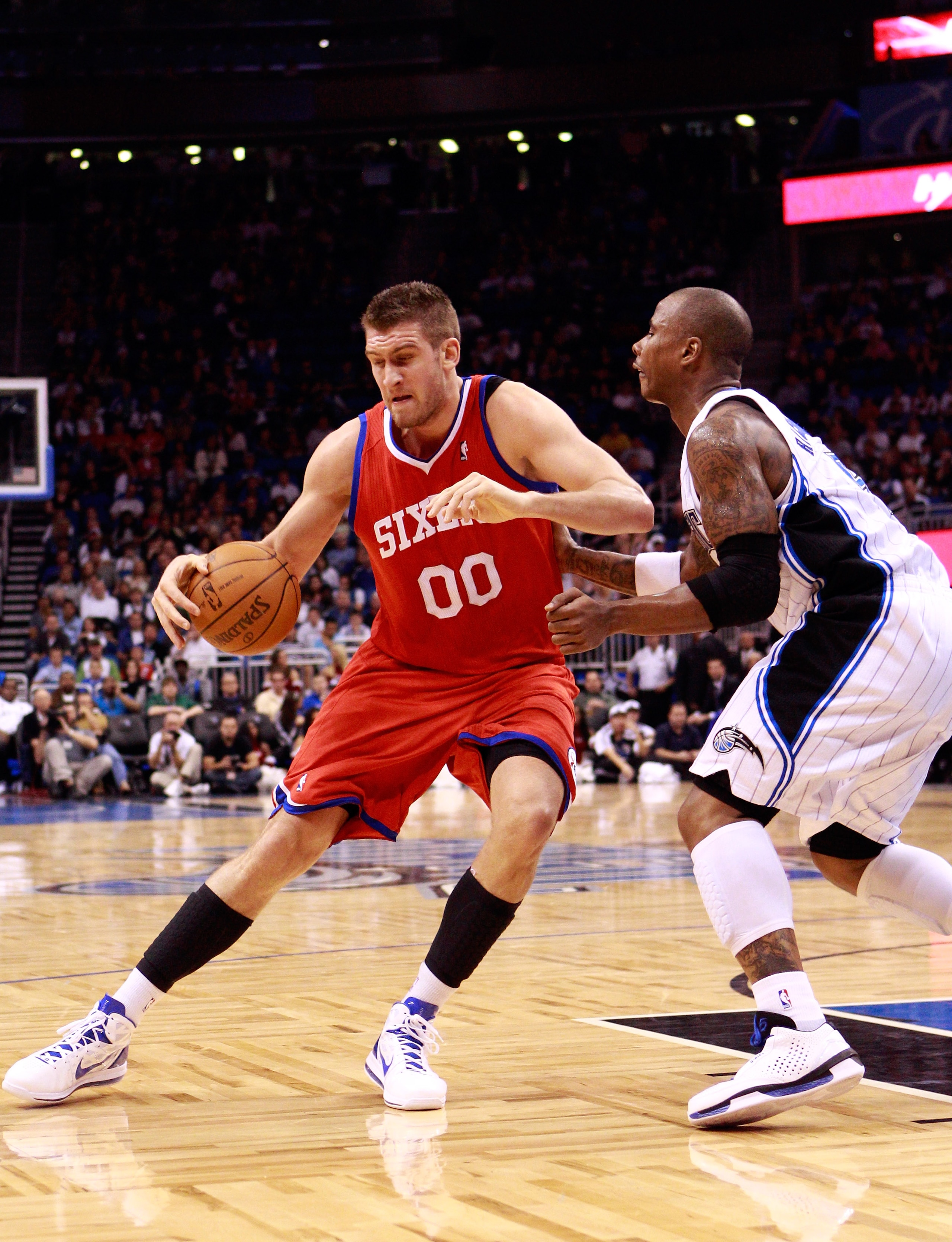 ORLANDO, FL - DECEMBER 18:  Spencer Hawes #00 of the Philadelphia 76ers is guarded by Quentin Richardson #5 of the Orlando Magic during the game at Amway Arena on December 18, 2010 in Orlando, Florida.  NOTE TO USER: User expressly acknowledges and agrees