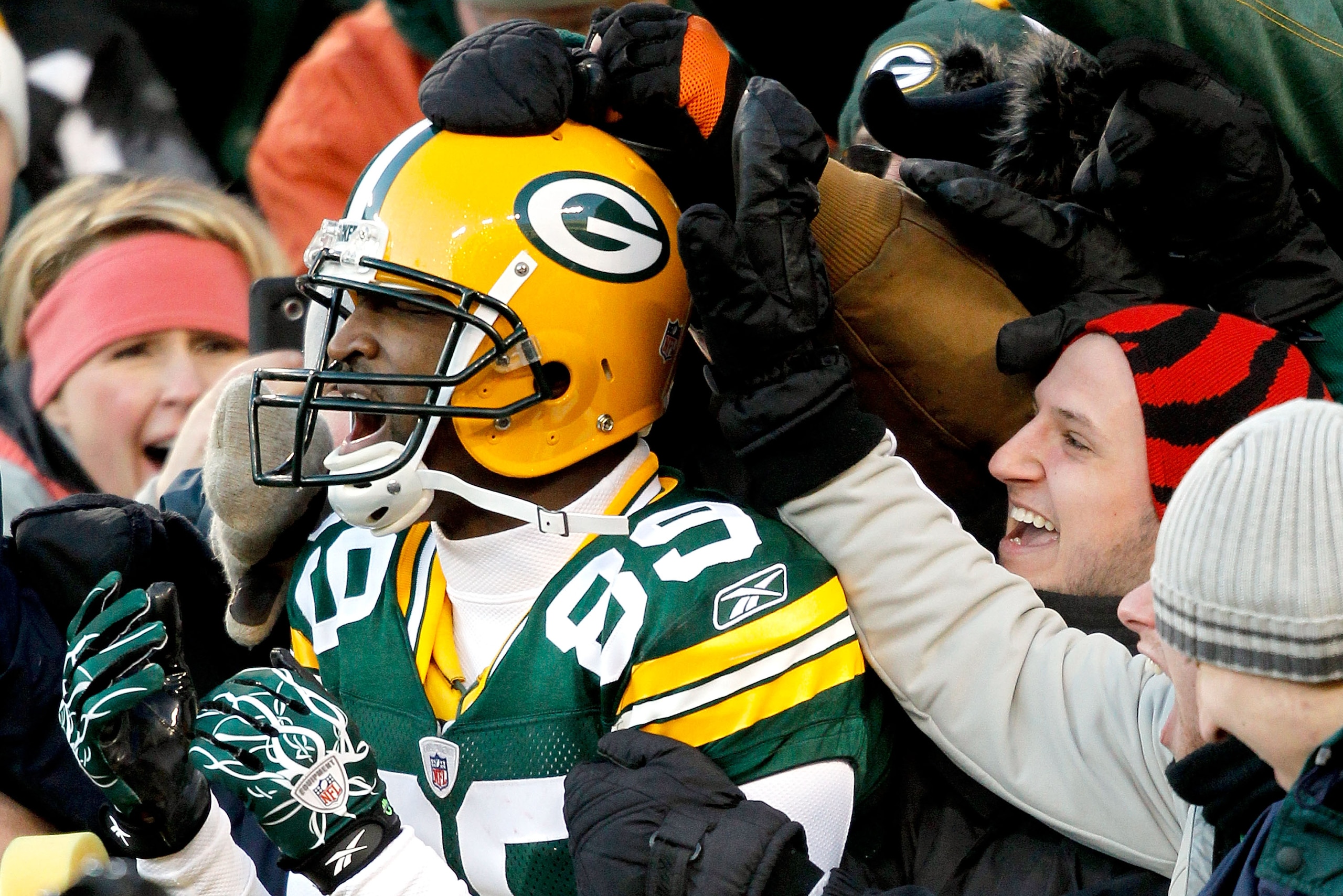 GREEN BAY, WI - DECEMBER 26:  James Jones #89 of the Green Bay Packers leaps into the stands after scoring a touchdown against the New York Giants at Lambeau Field on December 26, 2010 in Green Bay, Wisconsin.  (Photo by Matthew Stockman/Getty Images)