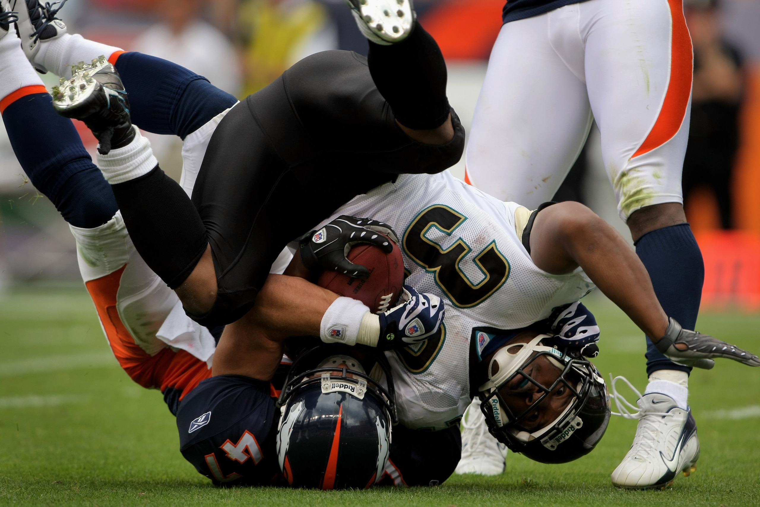 DENVER - SEPTEMBER 23:  Maurice Jones-Drew #32 of the Jacksonville Jaguars is tackled by John Lynch #47 of the Denver Broncos during week three NFL action at Invesco Field at Mile High on September 23, 2007 in Denver, Colorado. The Jaguars defeated the Br
