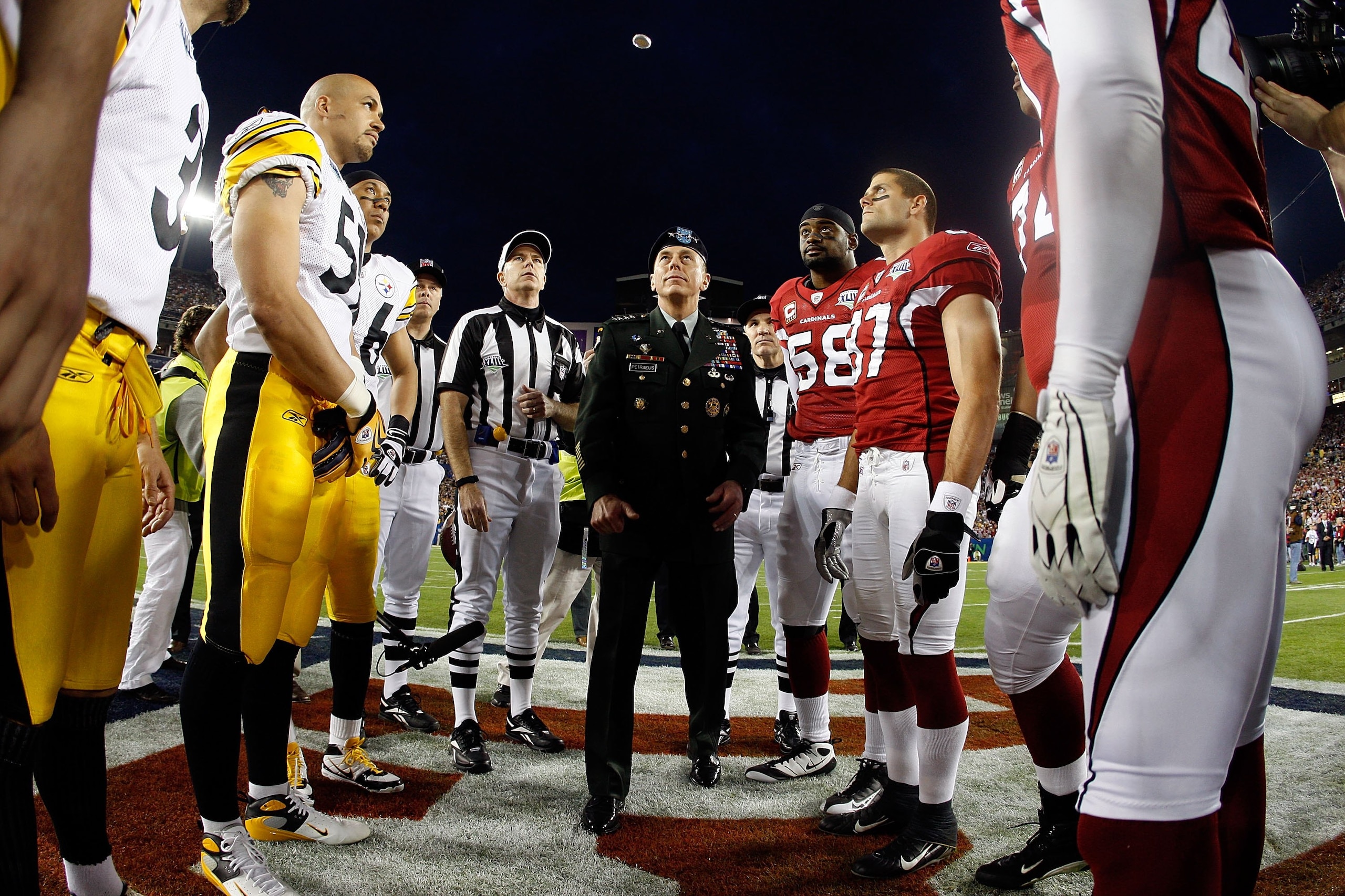 TAMPA, FL - FEBRUARY 01:  General David H. Petraeus, commander of the United States Central Command, performs the coin toss before Super Bowl XLIII between the Arizona Cardinals and the Pittsburgh Steelers on February 1, 2009 at Raymond James Stadium in T