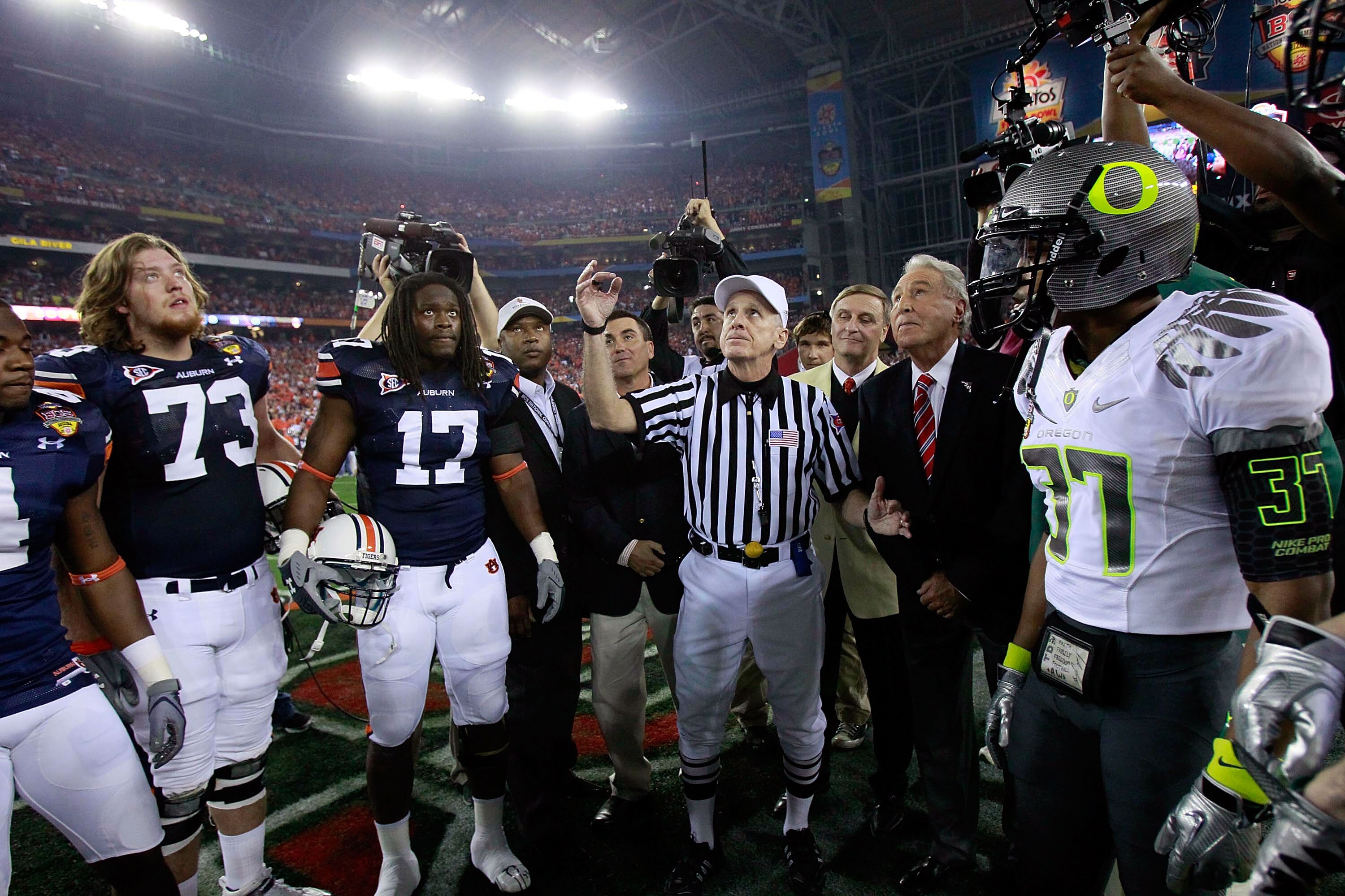 GLENDALE, AZ - JANUARY 10:  Big Ten referee Bill LeMonnier tosses a coin prior to the Tostitos BCS National Championship Game between the Auburn Tigers and the Oregon Ducks at University of Phoenix Stadium on January 10, 2011 in Glendale, Arizona.  (Photo