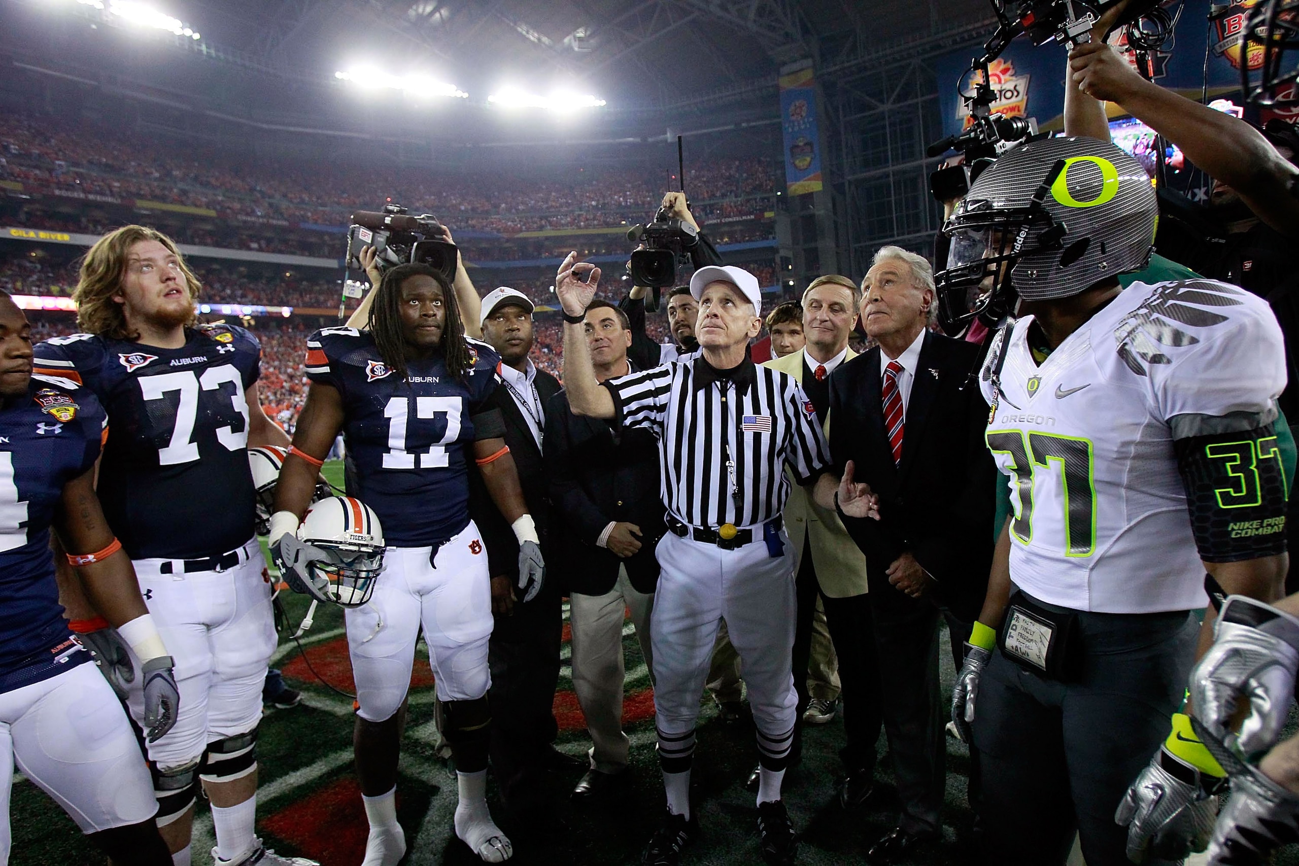 GLENDALE, AZ - JANUARY 10:  Big Ten referee Bill LeMonnier tosses a coin prior to the Tostitos BCS National Championship Game between the Auburn Tigers and the Oregon Ducks at University of Phoenix Stadium on January 10, 2011 in Glendale, Arizona.  (Photo