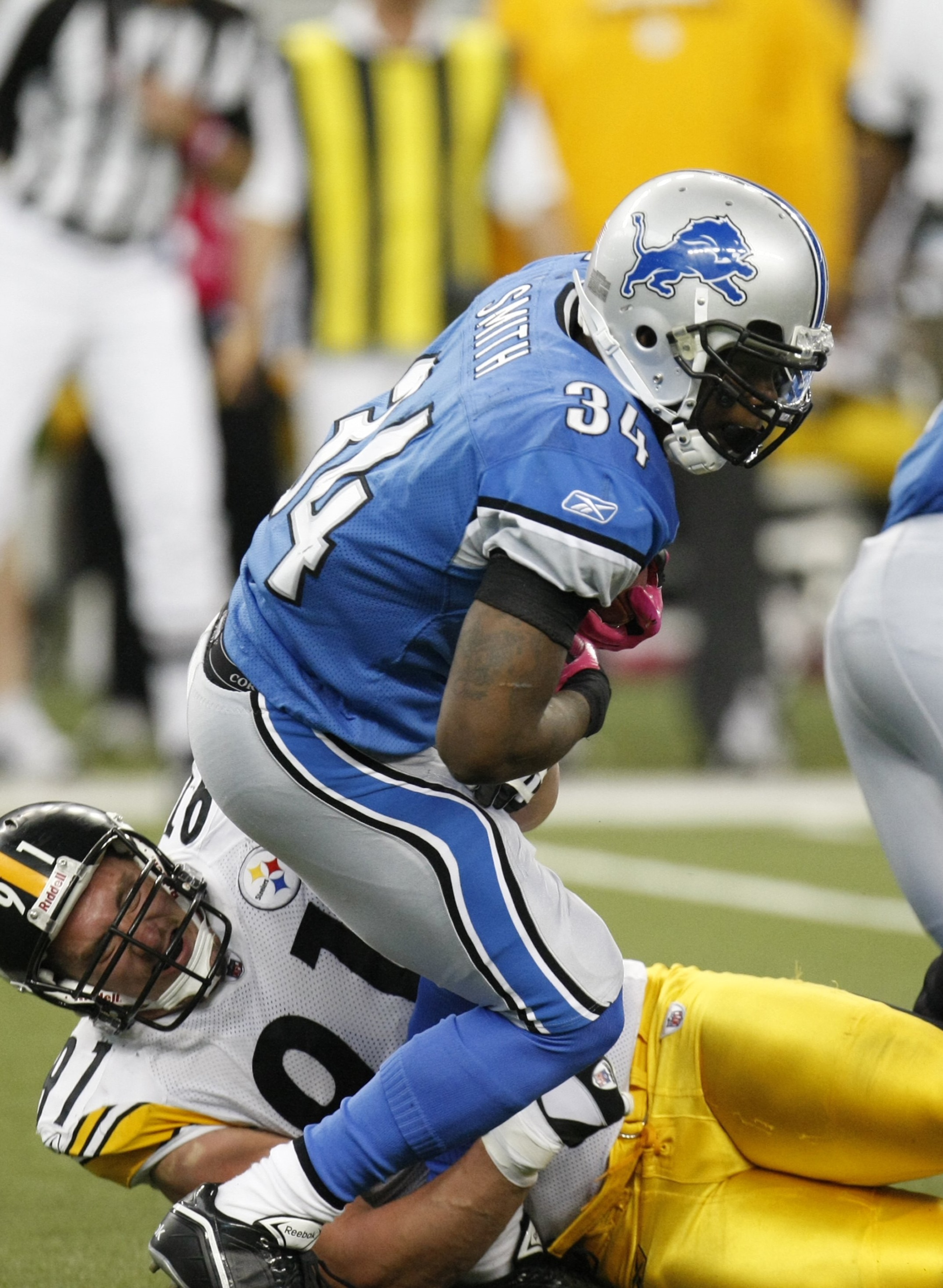 DETROIT - OCTOBER 11:  Kevin Smith #34 of the Detroit Lions runs the ball against Aaron Smith #91 of the Pittsburgh Steelers during their NFL game on October 11, 2009 at Ford Field in Detroit, Michigan. (Photo by Gregory Shamus/Getty Images)