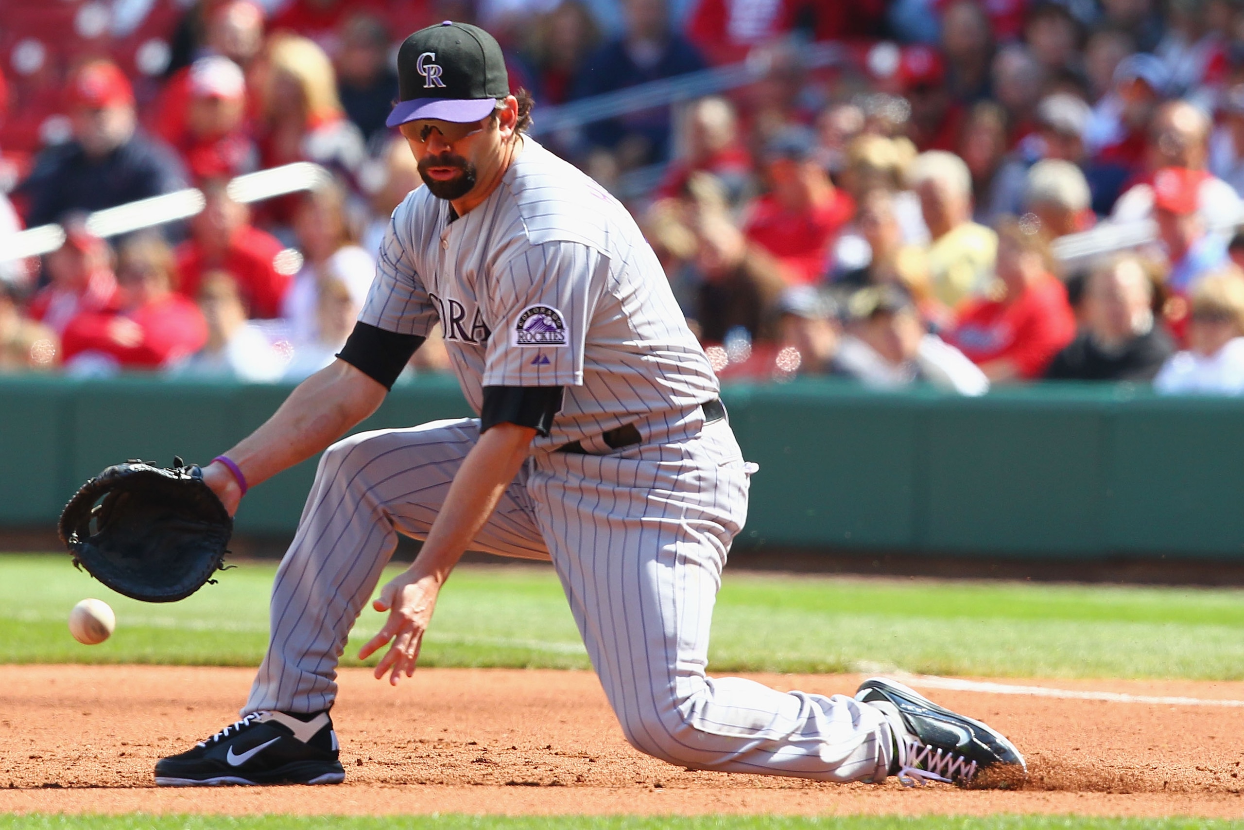 ST. LOUIS - OCTOBER 2: Todd Helton #17 of the Colorado Rockies mis plays a ground ball against the St. Louis Cardinals at Busch Stadium on October 2, 2010 in St. Louis, Missouri. The Cardinals beat the Rockies 1-0 in 11 innings. (Photo by Dilip Vishwana ST. LOUIS - OCTOBER 2: Todd Helton #17 of the Colorado Rockies mis plays a ground ball against the St. Louis Cardinals at Busch Stadium on October 2, 2010 in St. Louis, Missouri. The Cardinals beat the Rockies 1-0 in 11 innings. (Photo by Dilip Vishwana