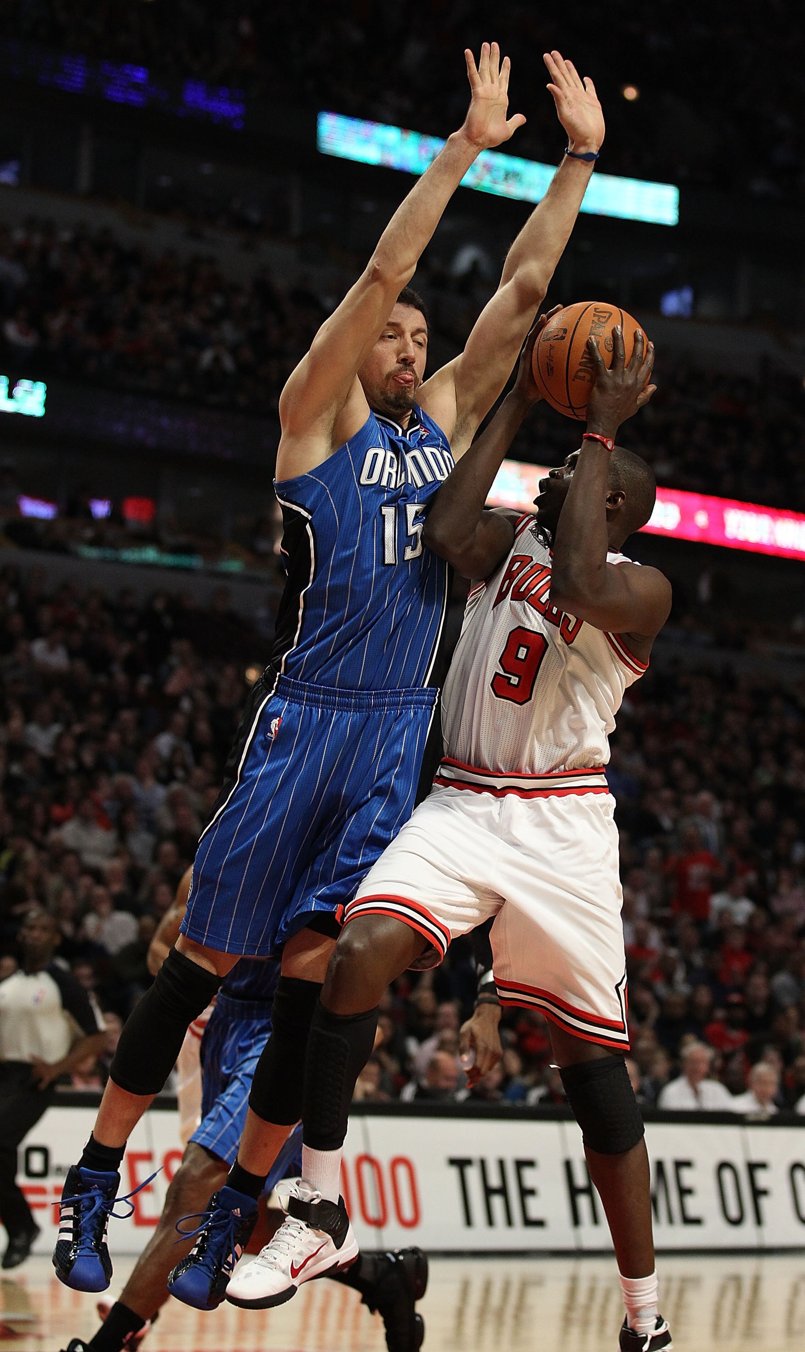 CHICAGO, IL - JANUARY 28: Loul Deng #9 of the Chicago Bulls puts up a shot against Hedo Turkoglu #15 of the Orlando Magic at the United Center on January 28, 2011 in Chicago, Illinois. The Bulls defeated the Magic 99-90. NOTE TO USER: User expressly ackno