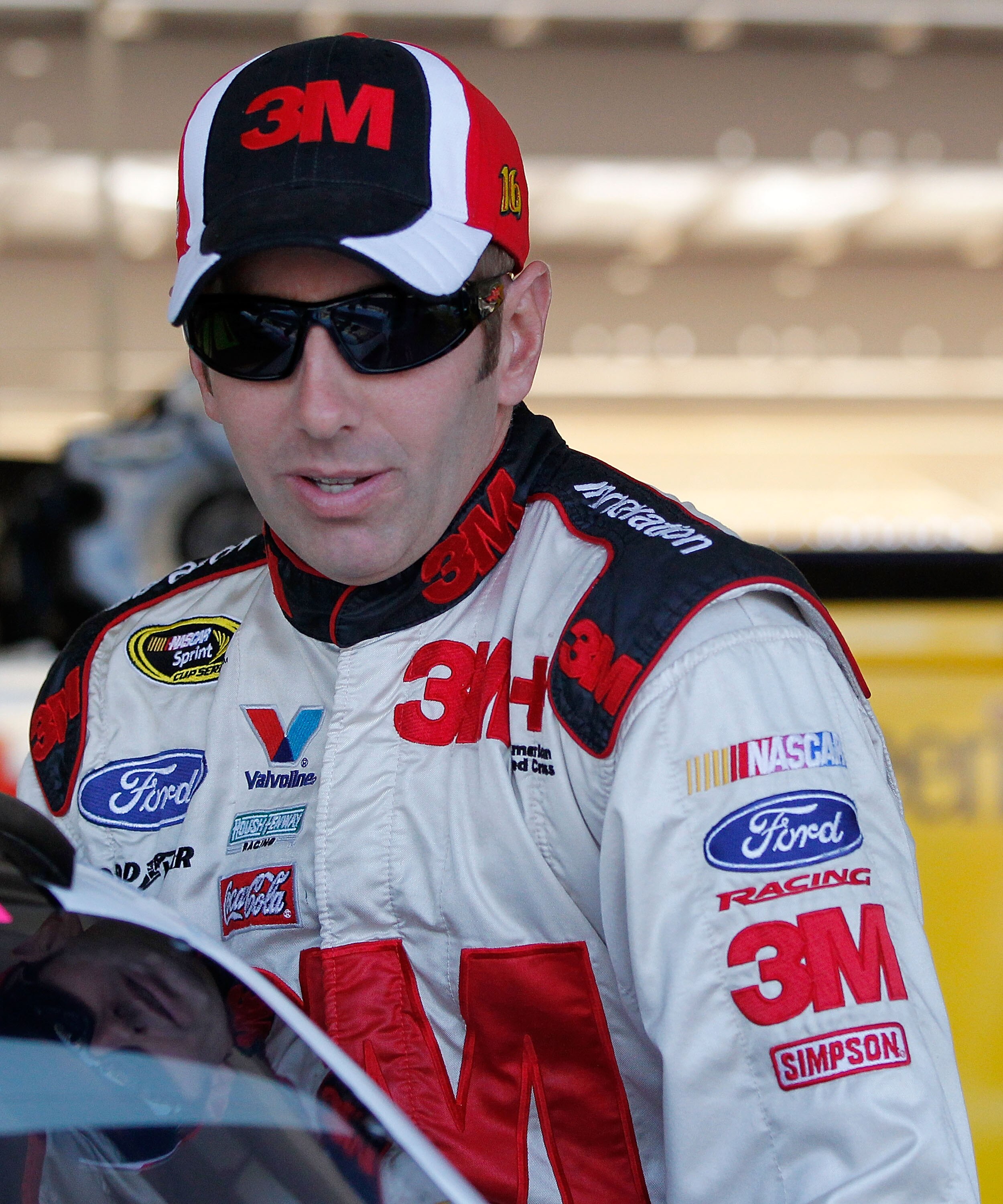AVONDALE, AZ - NOVEMBER 12: Greg Biffle, driver of the #16 3M Scotch Ford, climbs into his car in the garage prior to practice for the NASCAR Sprint Cup Series Kobalt Tools 500 at Phoenix International Raceway on November 12, 2010 in Avondale, Arizona.  (