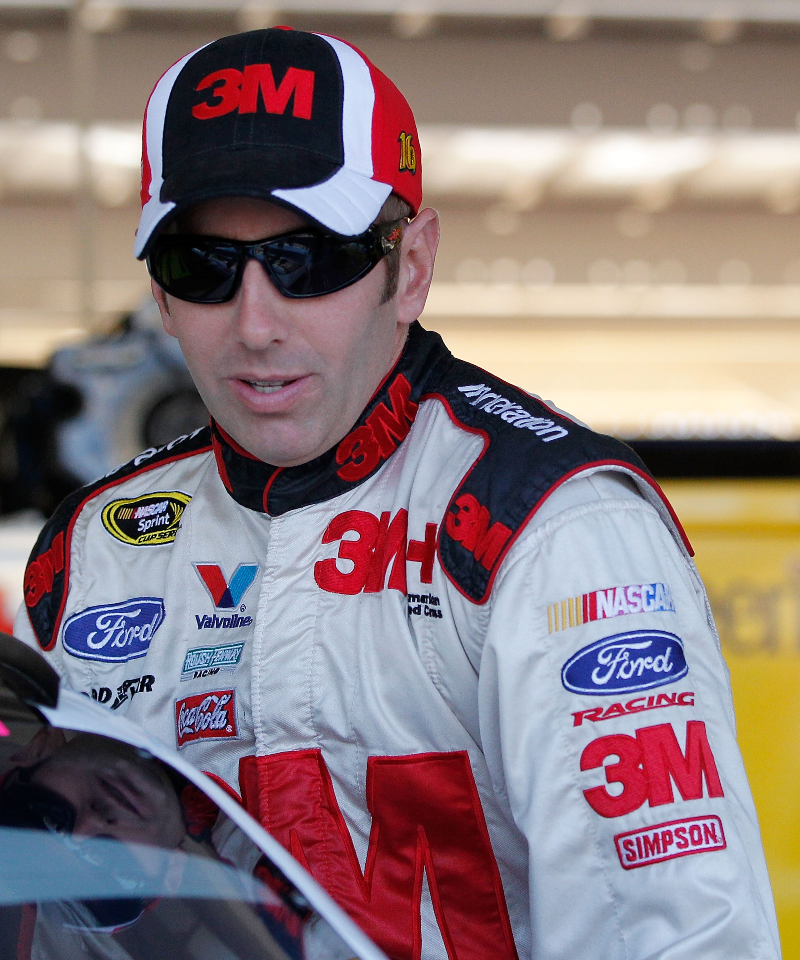 AVONDALE, AZ - NOVEMBER 12: Greg Biffle, driver of the #16 3M Scotch Ford, climbs into his car in the garage prior to practice for the NASCAR Sprint Cup Series Kobalt Tools 500 at Phoenix International Raceway on November 12, 2010 in Avondale, Arizona.  (