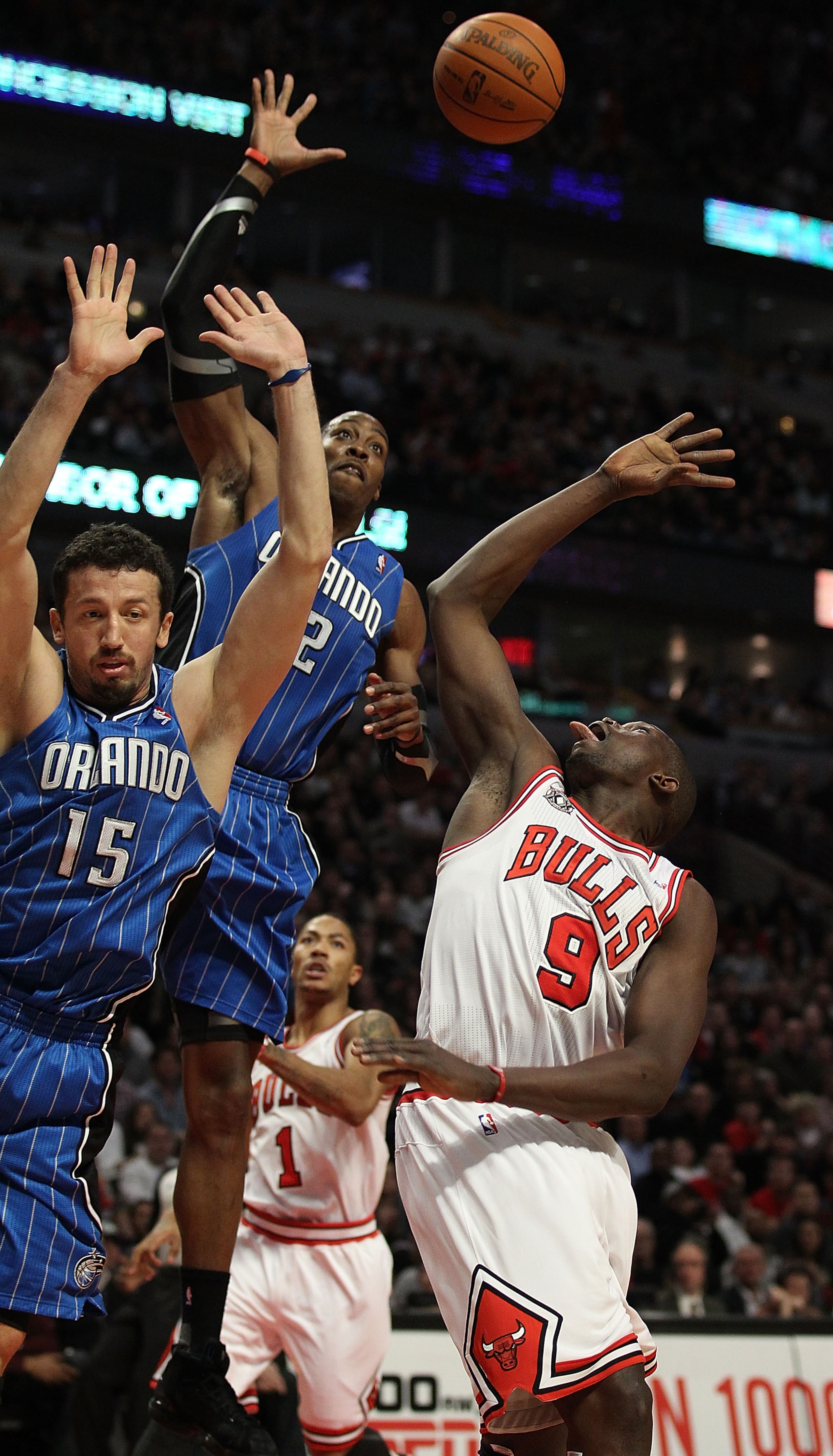 CHICAGO, IL - JANUARY 28: Dwight Howard #12 of the Orlando Magic leaps to block a shot by Loul Deng #9 of the Chicago Bulls as Hedo Turkoglu #15 defends at the United Center on January 28, 2011 in Chicago, Illinois. The Bulls defeated the Magic 99-90. NOT