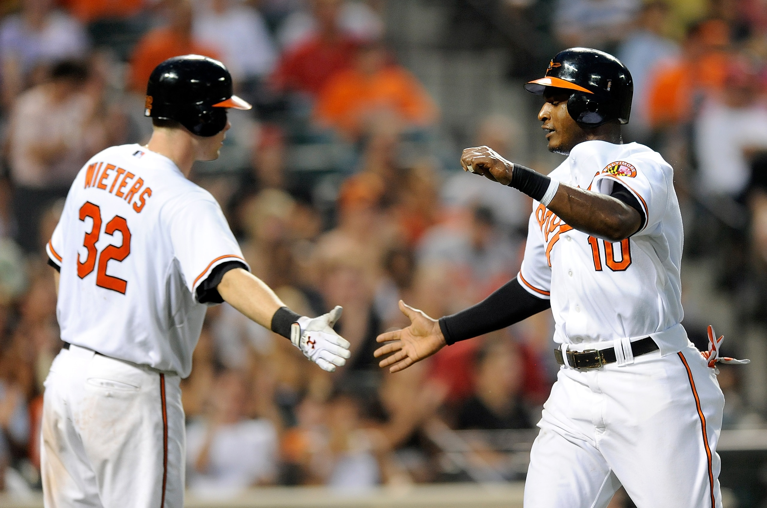 BALTIMORE - AUGUST 04: Adam Jones #10 of the Baltimore Orioles is congratulated by Matt Wieters #32 after scoring in the third inning against the Los Angeles Angels of Anaheim at Camden Yards on August 4, 2010 in Baltimore, Maryland. (Photo by Greg Fium BALTIMORE - AUGUST 04: Adam Jones #10 of the Baltimore Orioles is congratulated by Matt Wieters #32 after scoring in the third inning against the Los Angeles Angels of Anaheim at Camden Yards on August 4, 2010 in Baltimore, Maryland. (Photo by Greg Fium