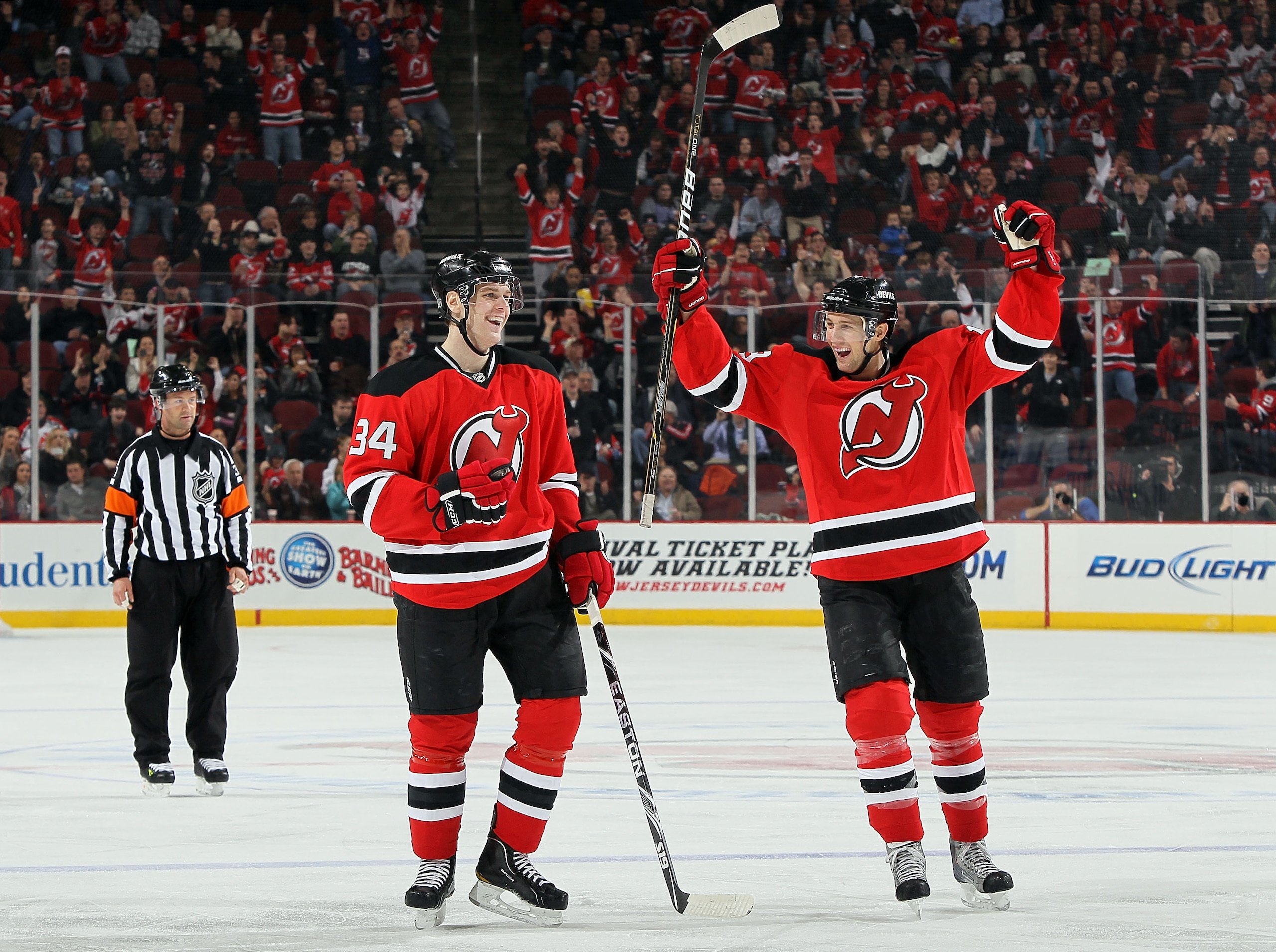 NEWARK, NJ - FEBRUARY 04:  Mark Fayne #34 of the New Jersey Devils celebrates his second period goal against the Florida Panthers with teammate Travis Zajac #19 at the Prudential Center on February 4, 2011 in Newark, New Jersey.  (Photo by Jim McIsaac/Get