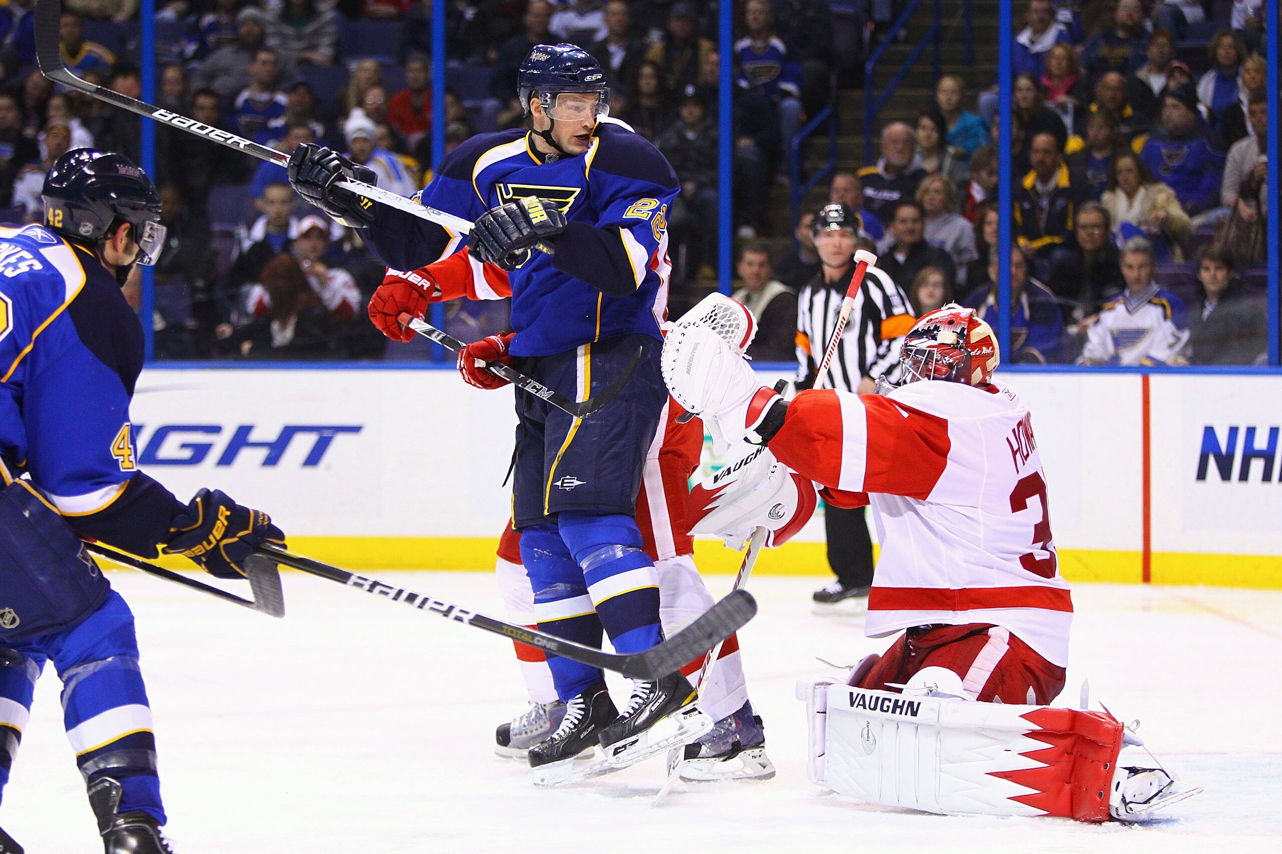 ST. LOUIS, MO - JANUARY 20: Jimmy Howard #35 of the Detroit Red Wings makes a save against Brad Boyes #22 of the St. Louis Blues at the Scottrade Center on January 20, 2011 in St. Louis, Missouri.  The Red Wings beat the Blues 4-3 in overtime.  (Photo by