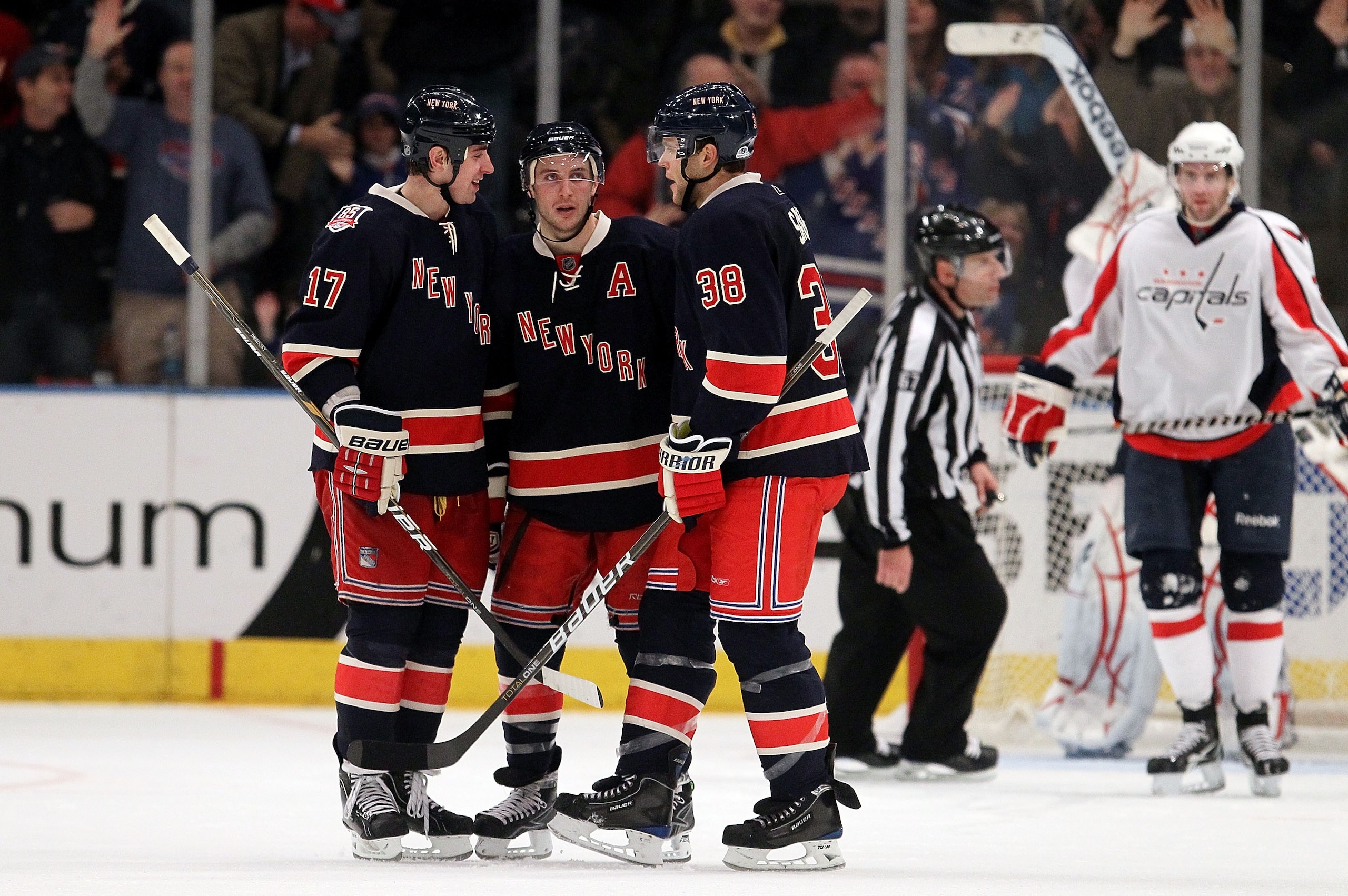 NEW YORK, NY - DECEMBER 12:  Ryan Callahan #24 of the New York Rangers celebrates his third period goal against the Washington Capitals with teammates Brandon Dubinsky #17 and Michael Sauer #38 on December 12, 2010 at Madison Square Garden in New York Cit