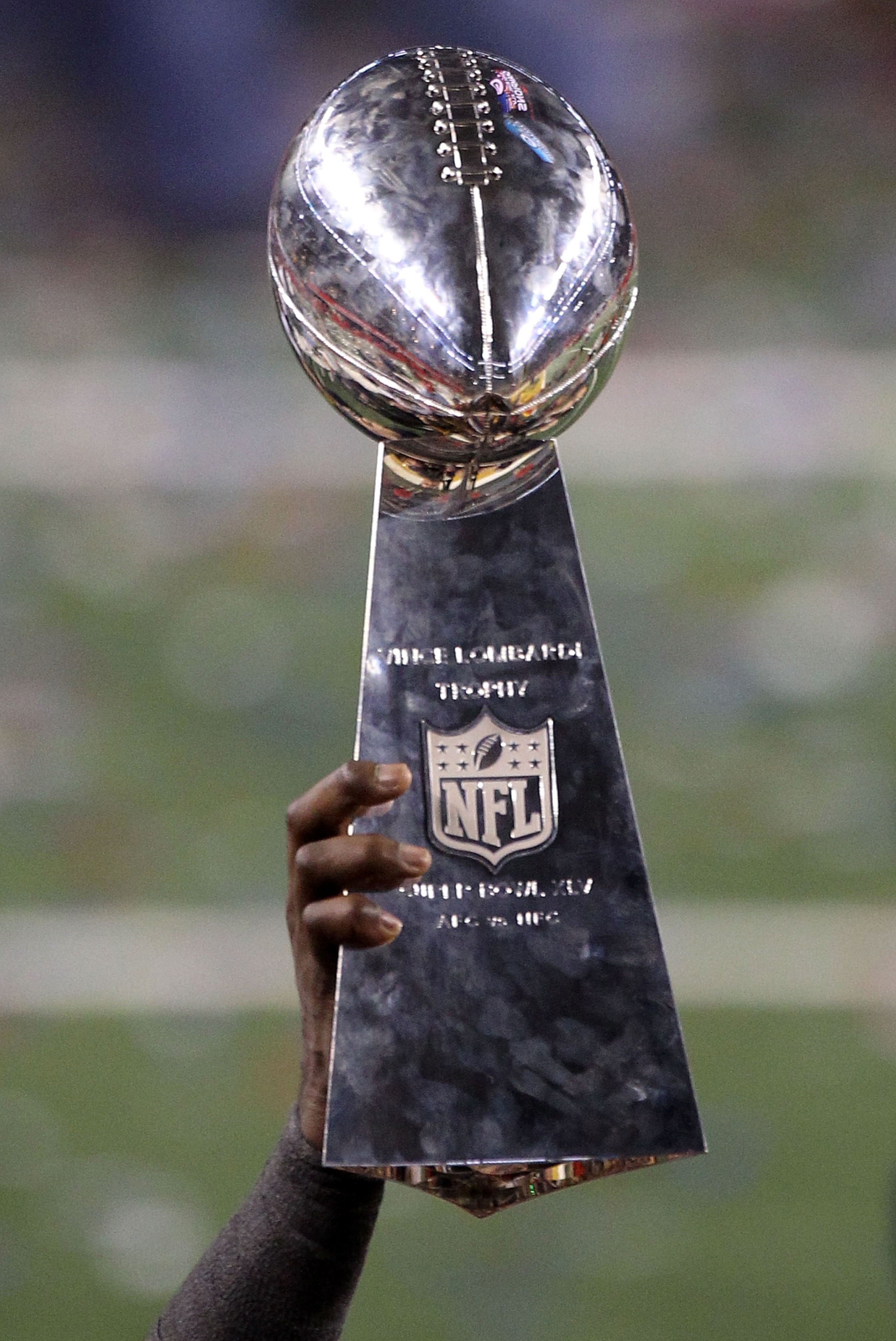 ARLINGTON, TX - FEBRUARY 06: The Vince Lombardi Trophy is help up after the Green Bay Packers won Super Bowl XLV against the Pittsburgh Steelers at Cowboys Stadium on February 6, 2011 in Arlington, Texas.  (Photo by Streeter Lecka/Getty Images)