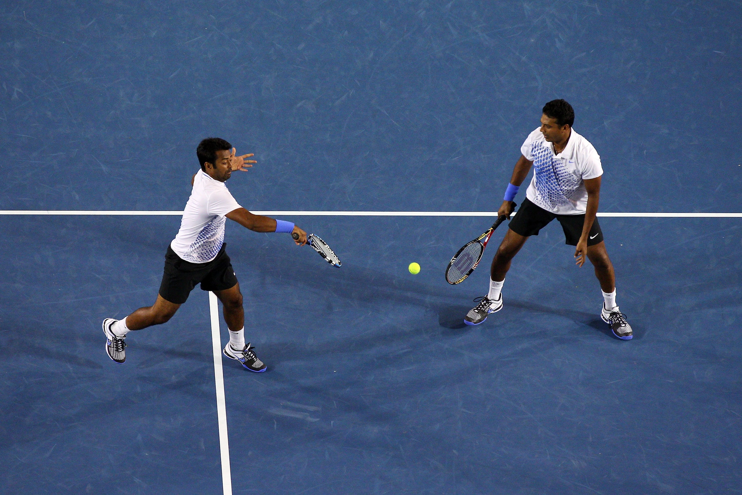 MELBOURNE, AUSTRALIA - JANUARY 29: Leander Paes of India plays a backhand in his men's doubles final match with Mahesh Bhupathi of India against Mike Bryan and Bob Bryan of the United States of America during day thirteen of the 2011 Australian Open at M MELBOURNE, AUSTRALIA - JANUARY 29: Leander Paes of India plays a backhand in his men's doubles final match with Mahesh Bhupathi of India against Mike Bryan and Bob Bryan of the United States of America during day thirteen of the 2011 Australian Open at M