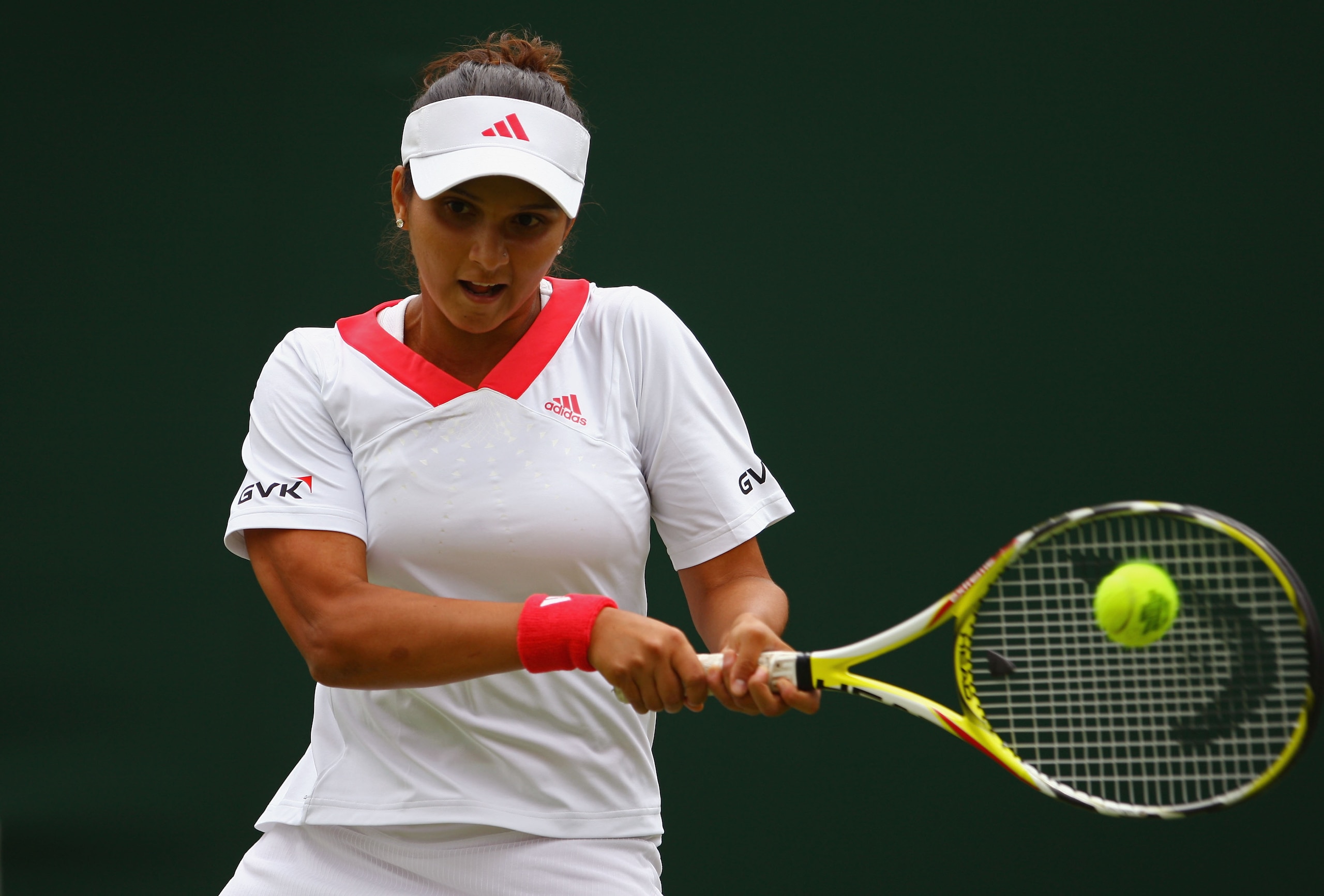 WIMBLEDON, ENGLAND - JUNE 22: Sania Mirza of India plays a backhand during the women's singles first round match against Anna-Lena Groenefeld of Germany on Day One of the Wimbledon Lawn Tennis Championships at the All England Lawn Tennis and Croquet Club WIMBLEDON, ENGLAND - JUNE 22: Sania Mirza of India plays a backhand during the women's singles first round match against Anna-Lena Groenefeld of Germany on Day One of the Wimbledon Lawn Tennis Championships at the All England Lawn Tennis and Croquet Club