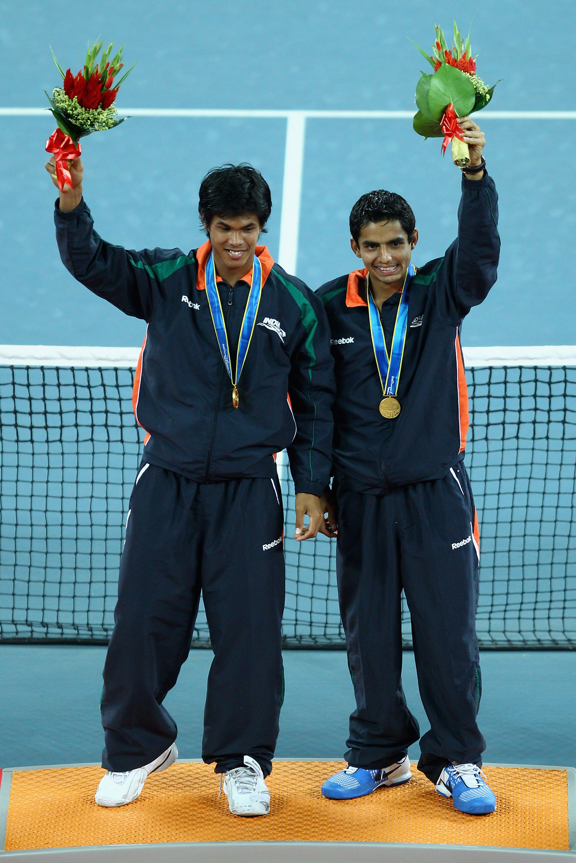 GUANGZHOU, CHINA - NOVEMBER 22:  Devvarman Sk and Sanam Krishan Singh of India celebrate winning the gold medal during the medal ceremony of the Men's Doubles Final tennis match at Aoti Tennis Centre during day ten of the 16th Asian Games Guangzhou 2010 o