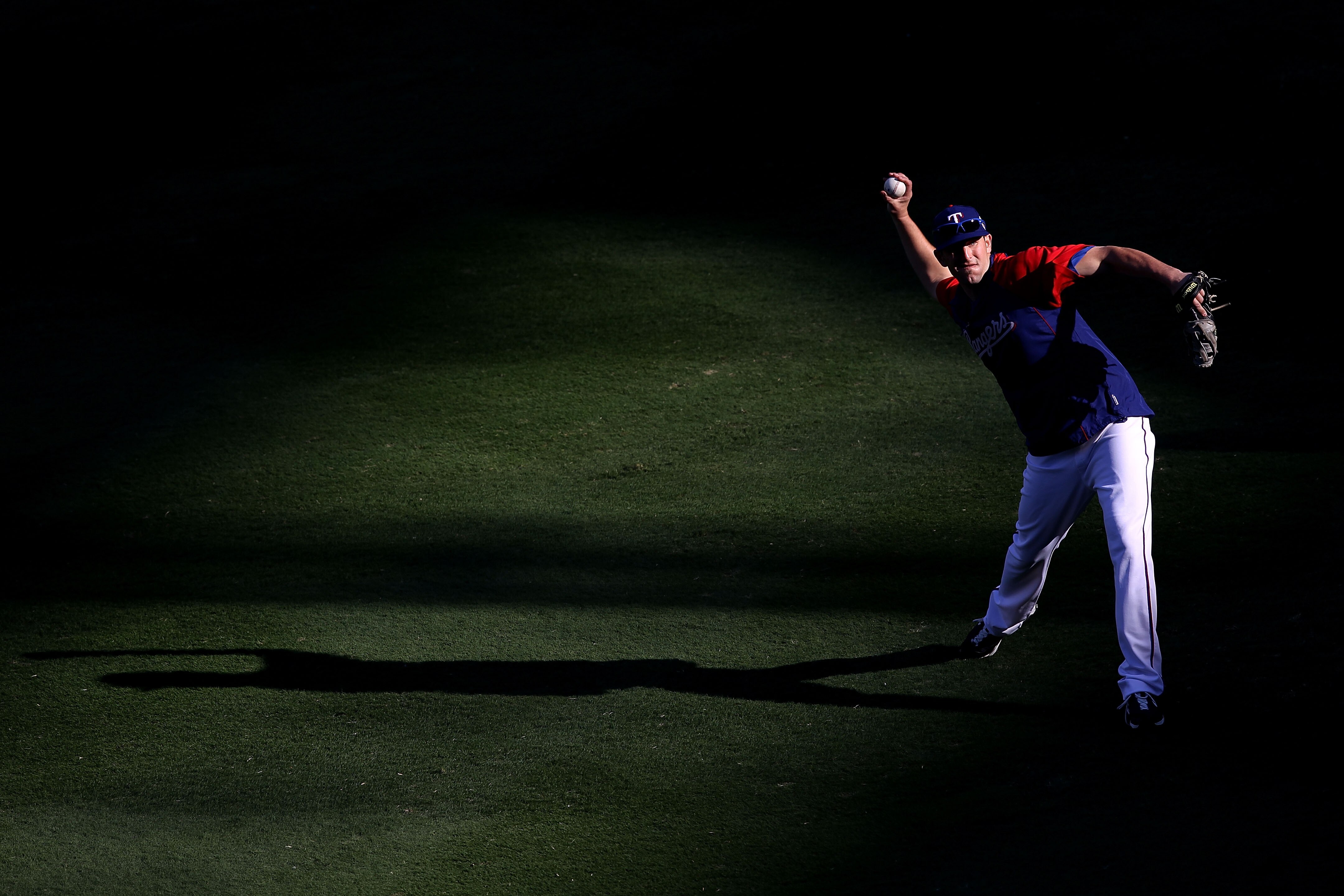 ARLINGTON, TX - NOVEMBER 01:  Darren O'Day of the Texas Rangers warms up against of the San Francisco Giants in Game Five of the 2010 MLB World Series at Rangers Ballpark in Arlington on November 1, 2010 in Arlington, Texas.  (Photo by Christian Petersen/